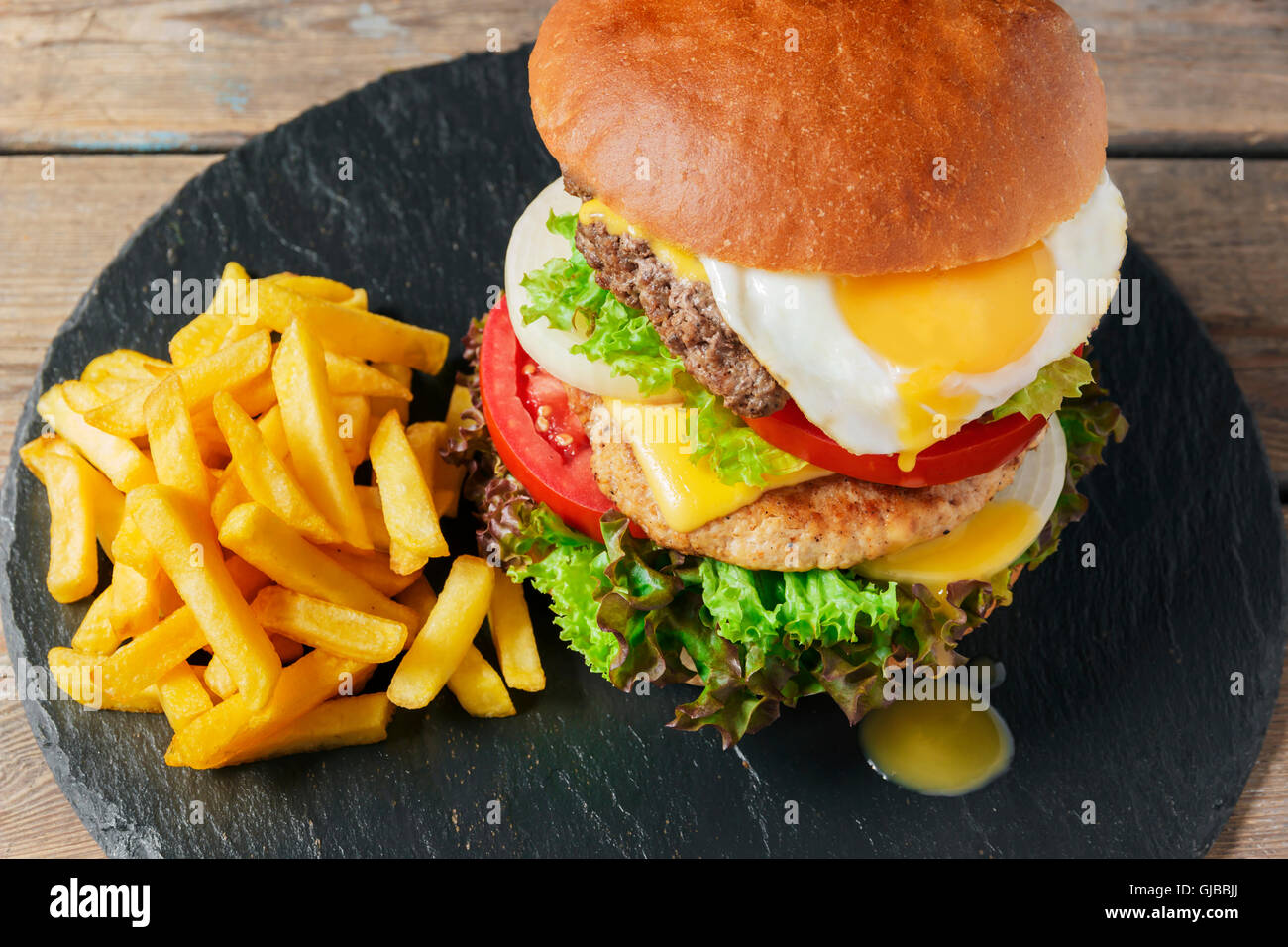 hamburger meat cutlet egg cheese french fries Stock Photo