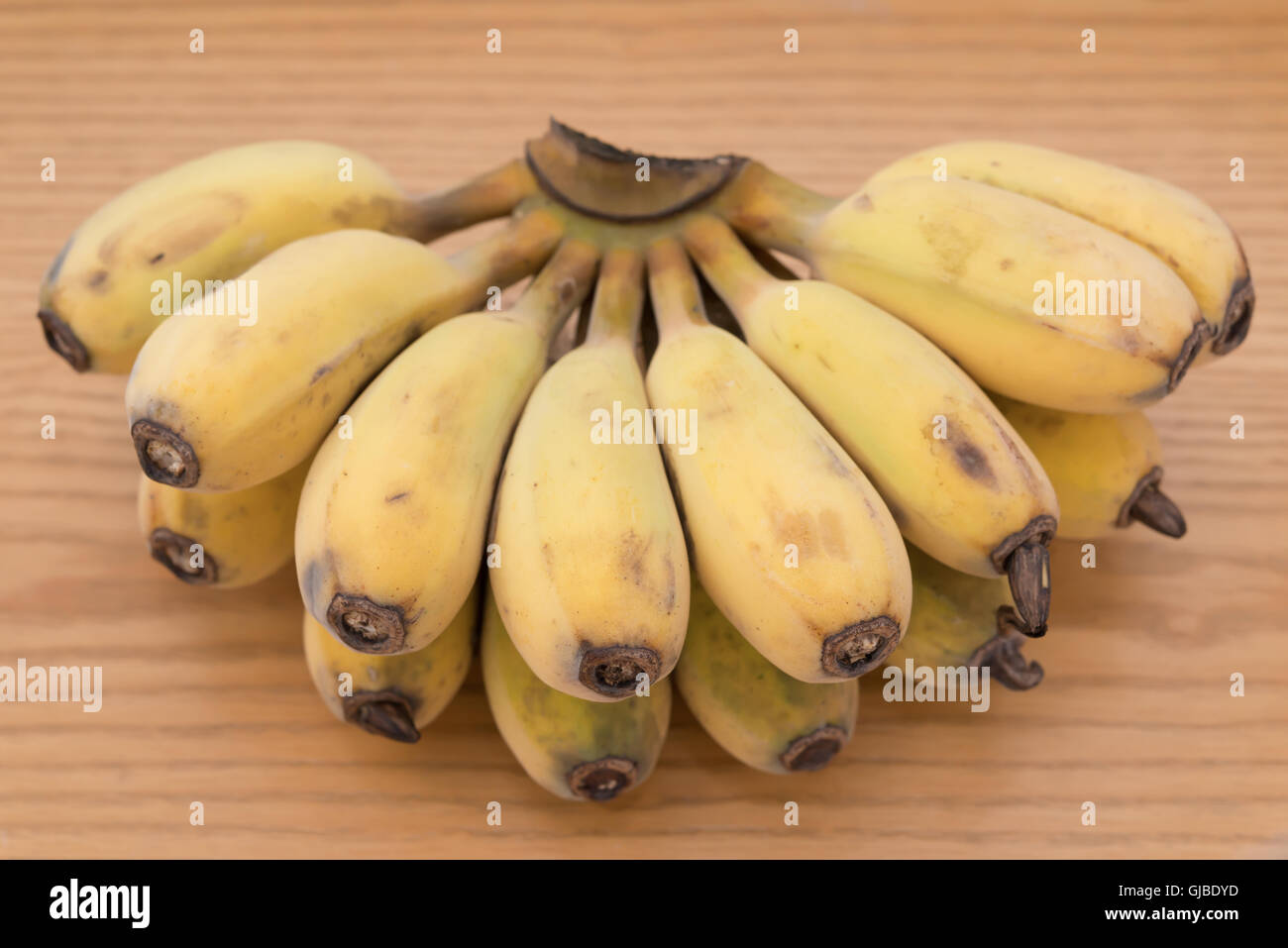 bunch of fresh bananas on a wood background Stock Photo