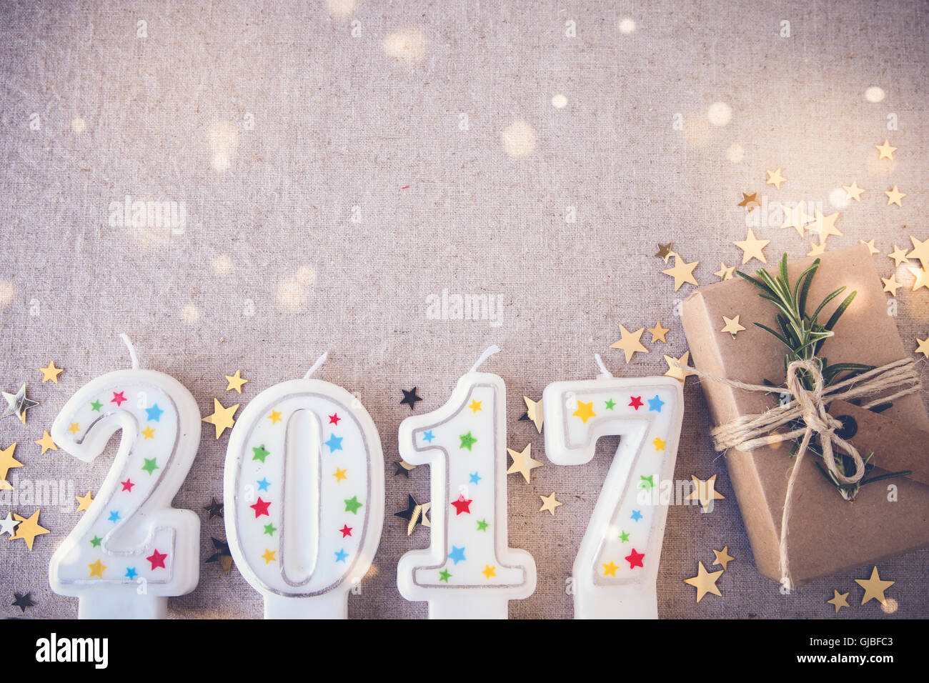 2017 candles with eco present boxes, New Year copy space fairy light toning background Stock Photo
