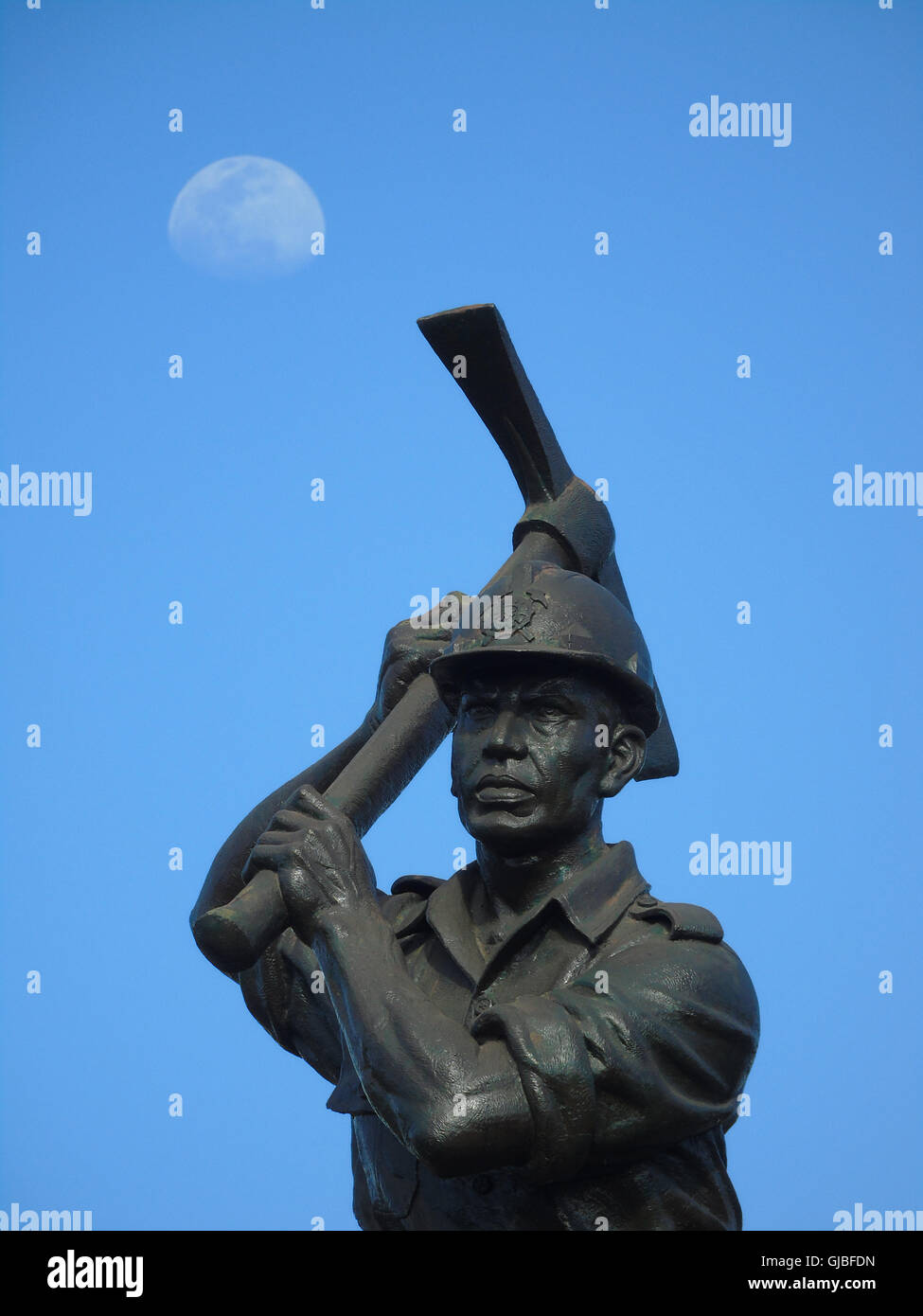 Miner statue with moon background on August 14, 2016 in Bintan island, Indonesia. Photo by Yuli Seperi Stock Photo