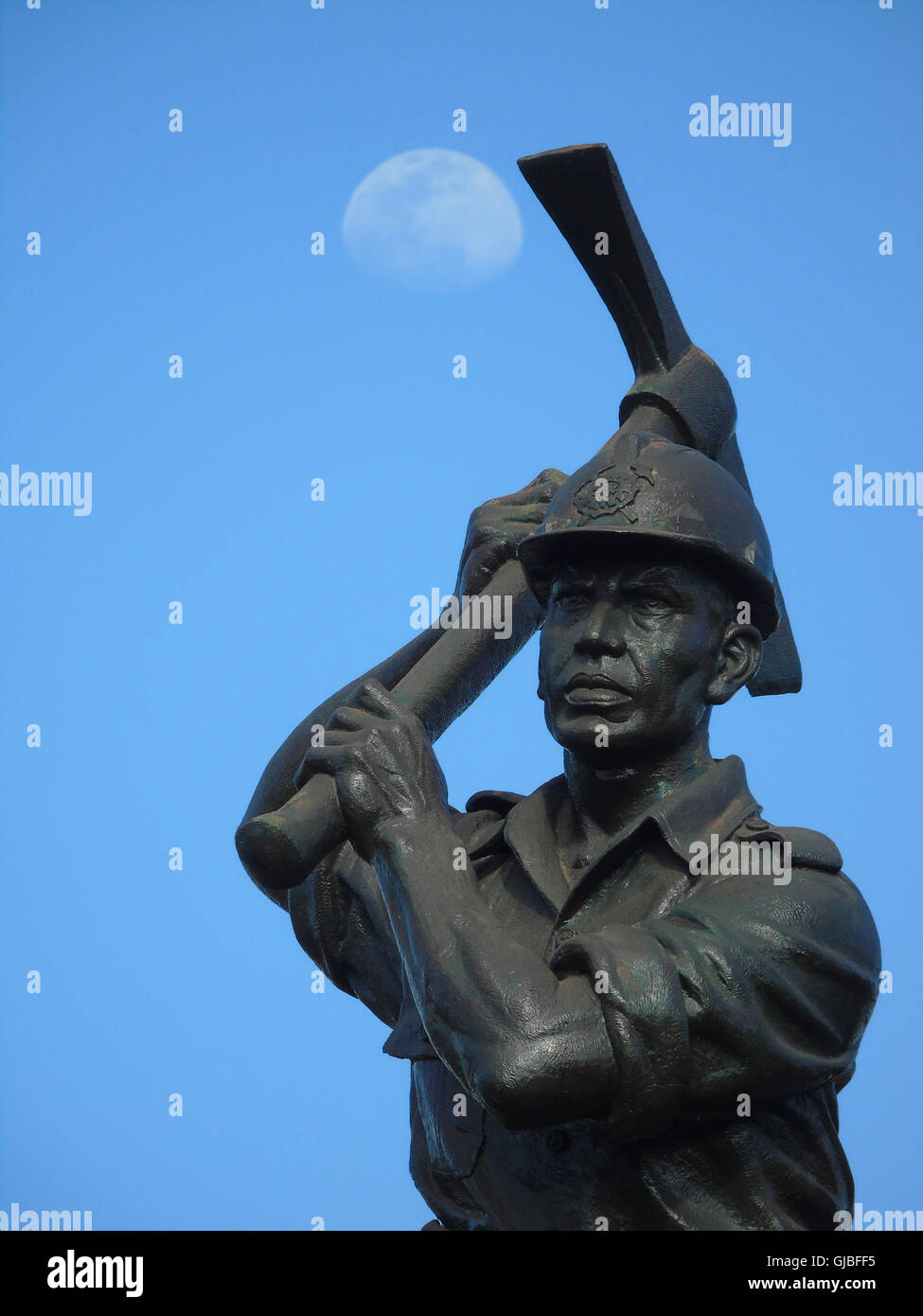 Miner statue with moon background on August 14, 2016 in Bintan island, Indonesia. Photo by Yuli Seperi Stock Photo