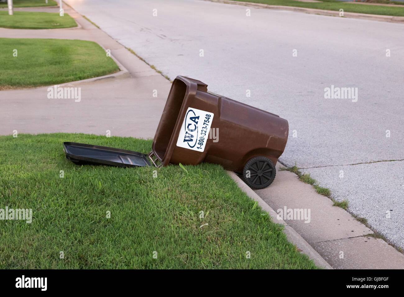 Tipped over garbage bin on street Stock Photo Alamy