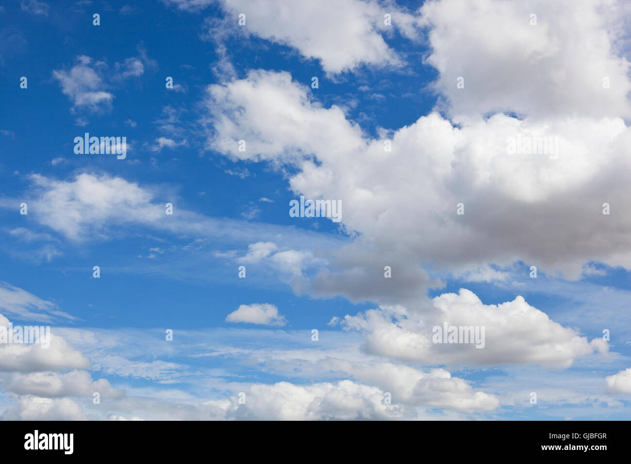 A blue sky background image with fluffy white clouds in summer Stock ...