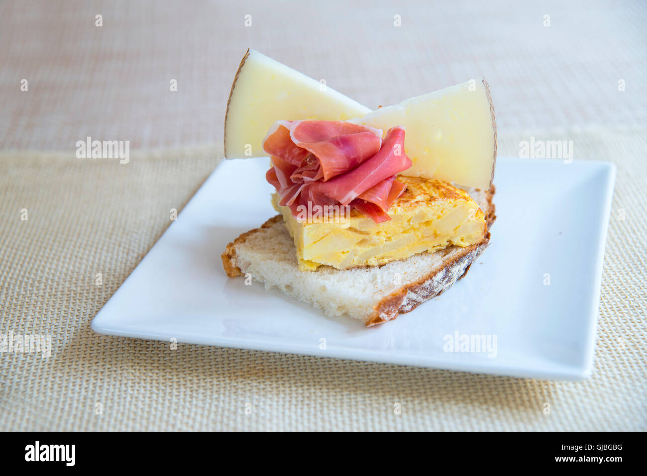 Spanish tapa Spanish omelet, Iberian ham and Manchego cheese Stock