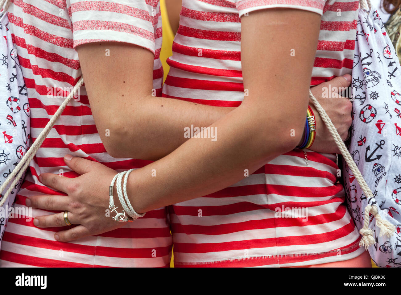 LGBT couple, Two lovers in embrace, hug, in arms, same striped clothes, Prague Pride, Czech Republic Stock Photo