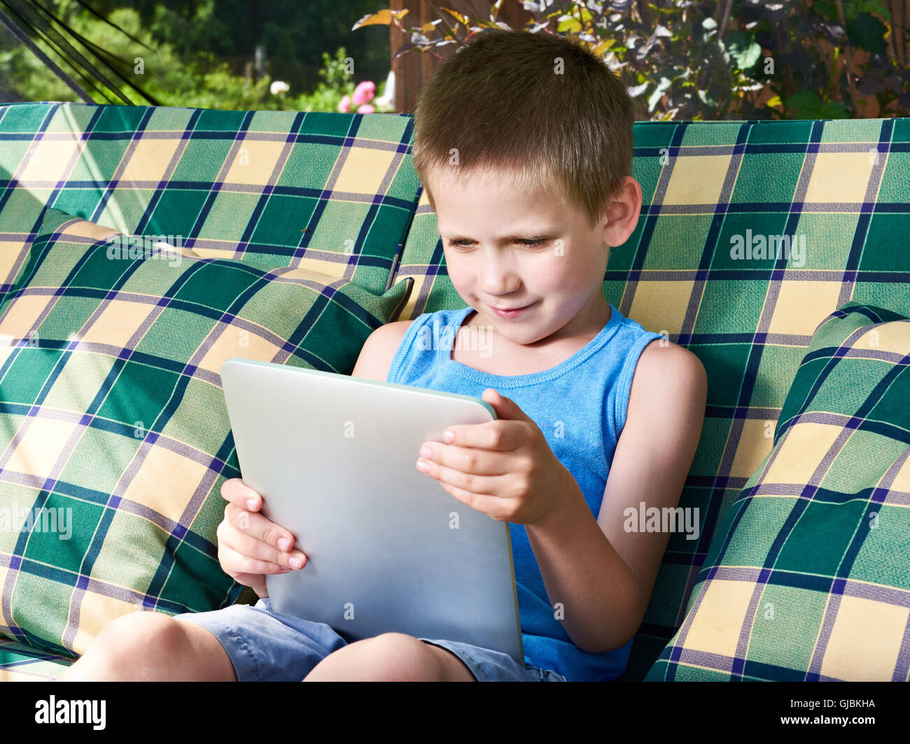 Little boy with tablet pc in summer day Stock Photo - Alamy