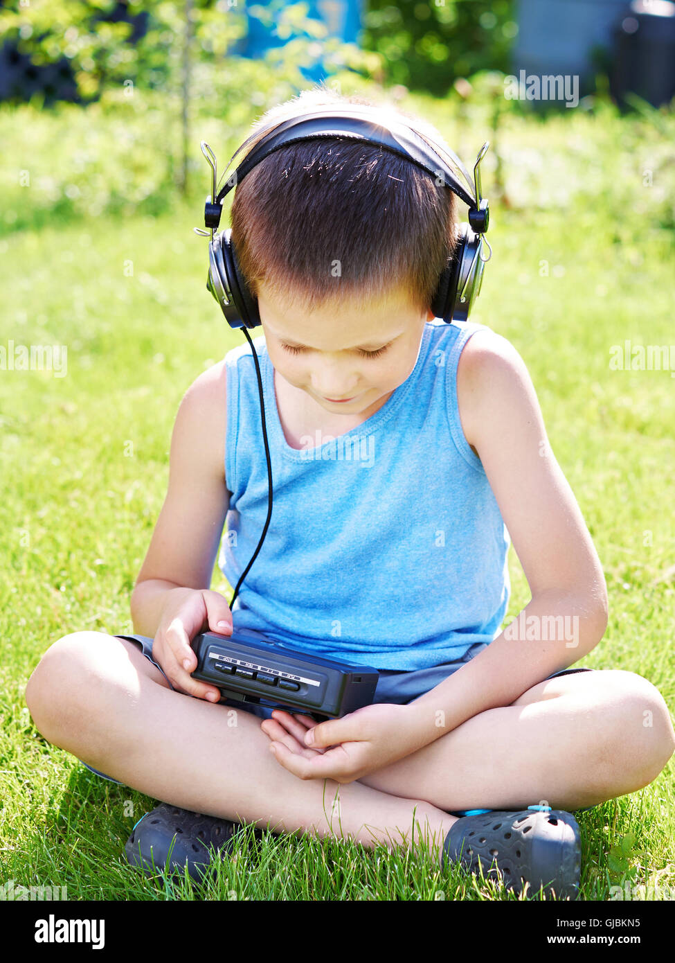 Little boy with old audio cassette player and headphones Stock Photo