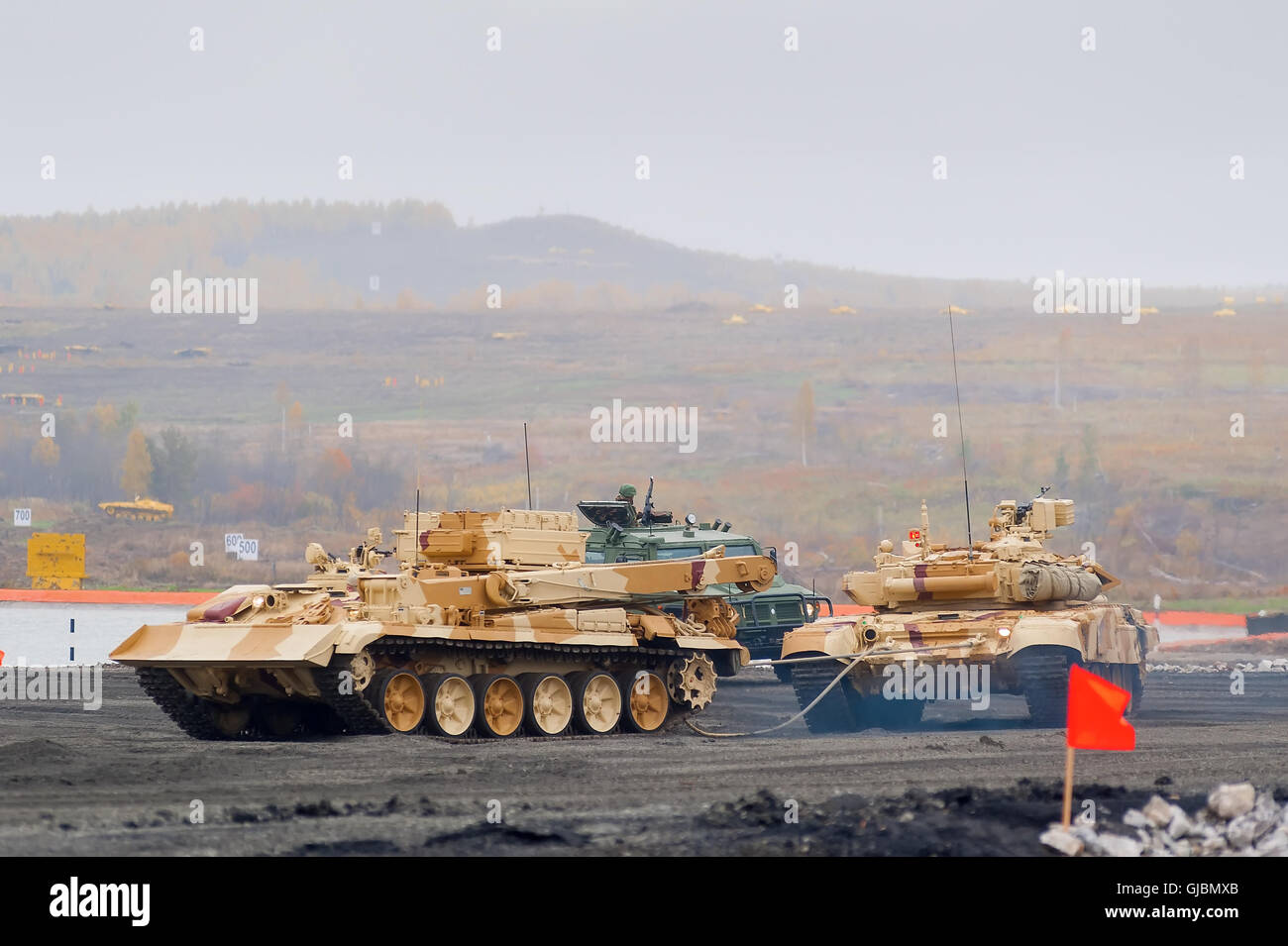 Armoured recovery vehicle BREM-1M evacuates tank Stock Photo