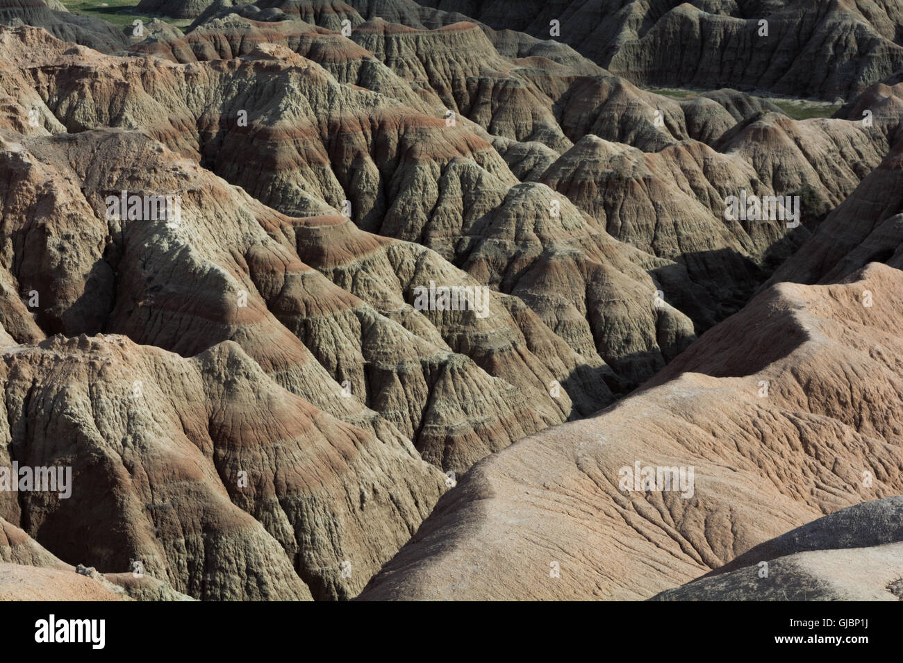 Erosion has created numerous small ravines and valleys out of the sandstone of the Badlands. Stock Photo