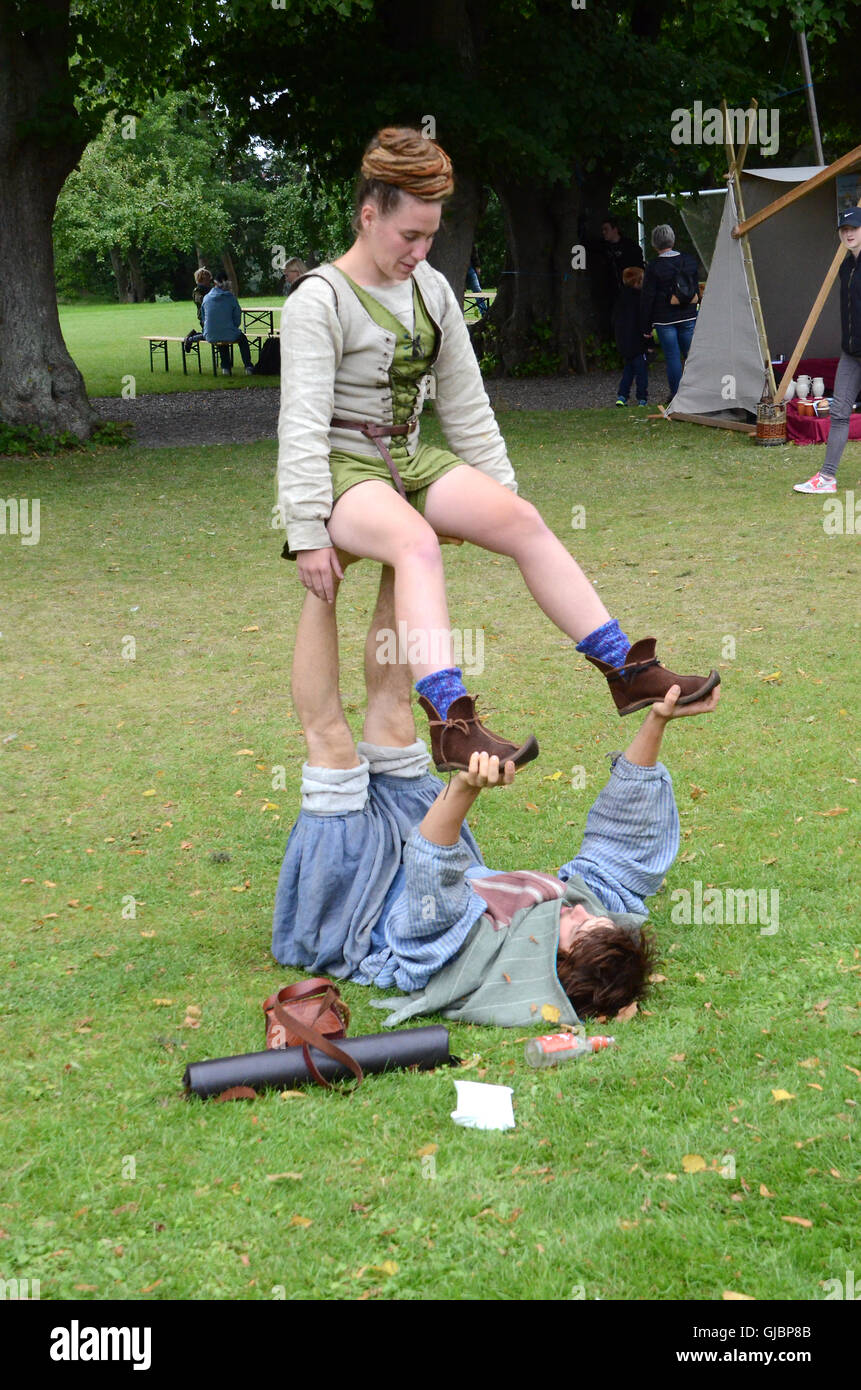 Two acrobats perform at a mid age festival. Stock Photo
