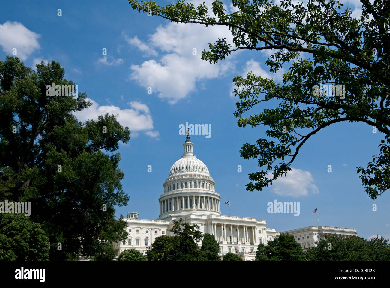 The US Capitol Building where the House of Representatives is in session under the flag flying on the right. Stock Photo