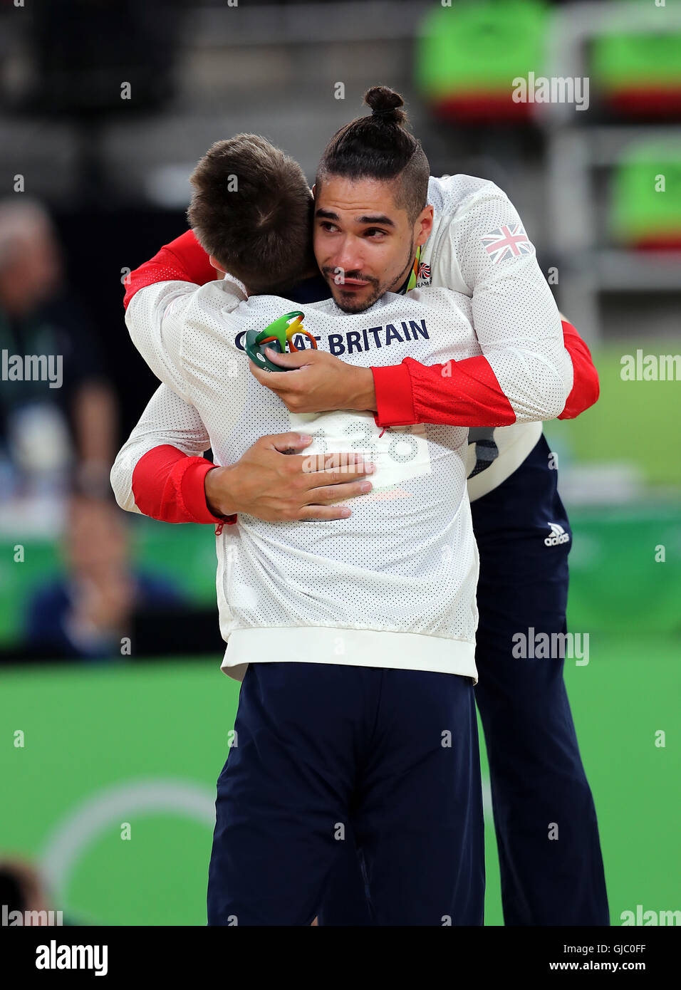Great Britain's Louis Smith is embraced by Olympic champion Max