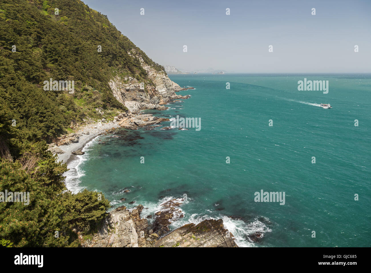 View of ocean, rocky coastline and lush cliff at the Taejongdae Resort ...