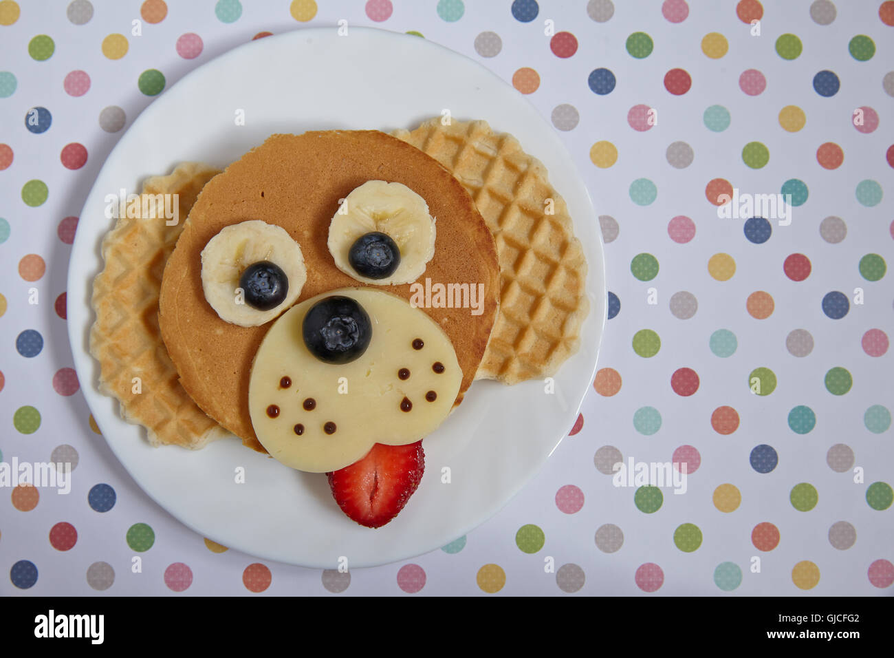 Funny dog pancake with berries for kids breakfast Stock Photo Alamy