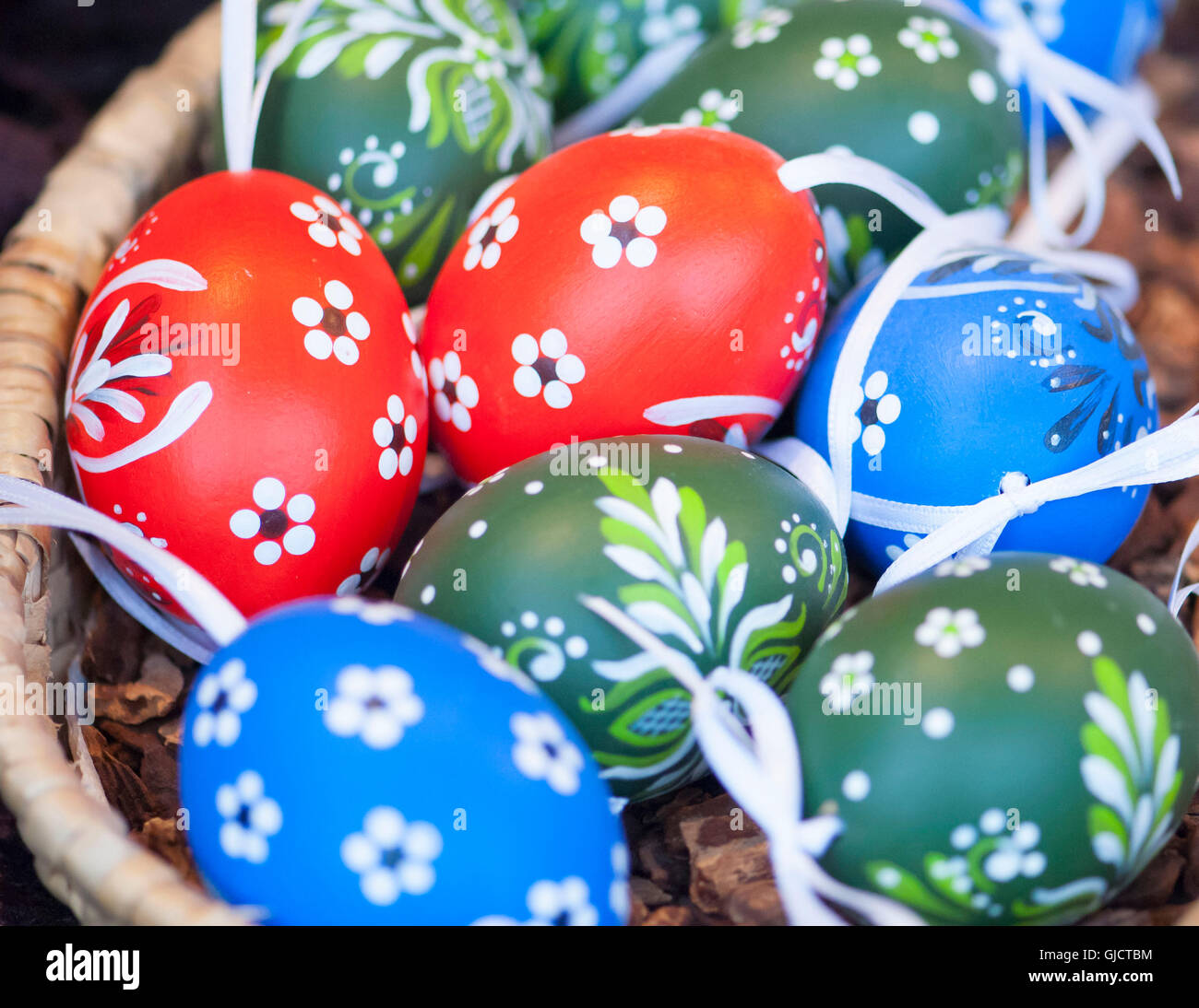 Coloured Easter eggs in Easter basket Stock Photo - Alamy