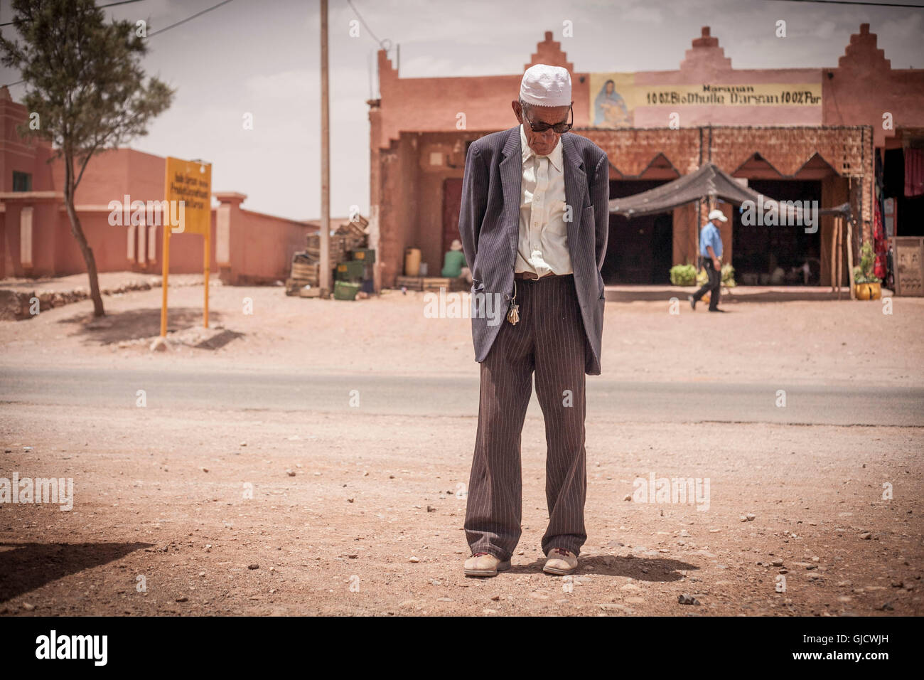 wrinkeld face, old man is looking on the ground, pious, internal calm, charisma, Morocco, Ouarzazate Stock Photo