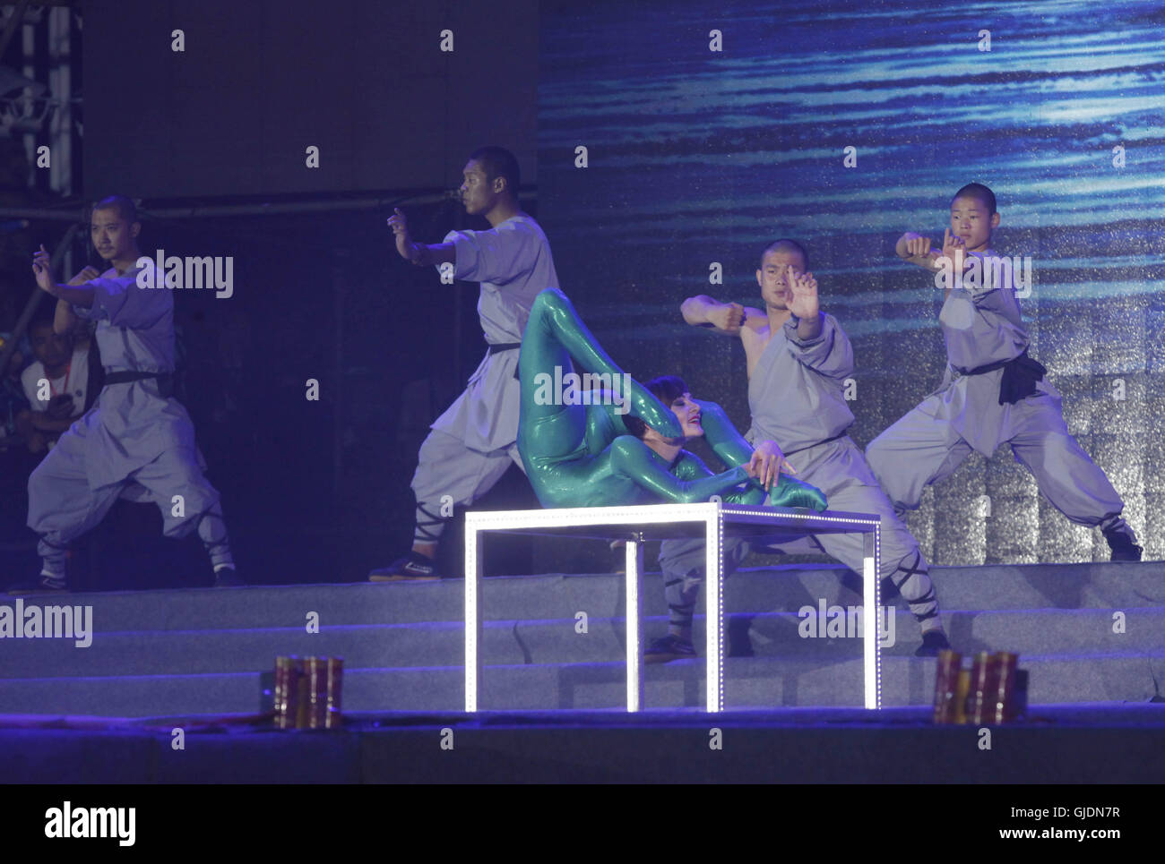 Heihe, China. 15th Aug, 2016. The well-known Russian contortionist Eliza performs with Chinese Shaolin Monks at the opening ceremony of the 7th China-Russia Cultural Fair, showing the beauty of Jiujitsu and martial arts. The Chinese Shaolin monks perform outstanding Shaolin martial arts including Shaolin Sticks, Shaolin Swords and headbutt, demonstrating the charms of gentleness and strength. Stock Photo