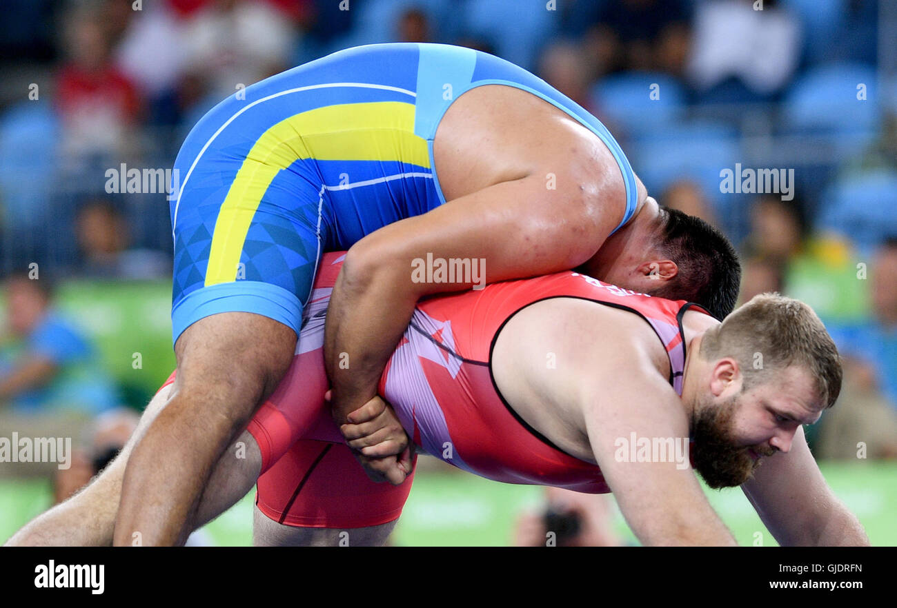 Rio de Janeiro, Brazil. 15th Aug, 2016. Eduard Popp (red) of Germany and  Nurmakhan Tinaliyev of Kazakhstan in action during the Men's Greco-Roman  130 kg 1/8 Final of the Wrestling events during