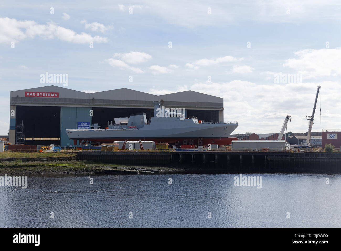 Glasgow, Scotland, UK 15th August 2016. HMS Forth sees the light of day on the banks of the BAE’s Govan shipyard. On the Clyde today although classed as River-class it has closer relations of the Amazonas class of patrol vessels built for the Brazilian Navy. Bearing the names of three of the UK’s principal waterways, Trent, Forth, and Medway, these ships are the main source of the current Clyde work. BAE received a £348 million contract to build the three vessels in August 2014. A completed hull is an unusual site these days on the river. Credit:  Gerard Ferry/Alamy Live News Stock Photo