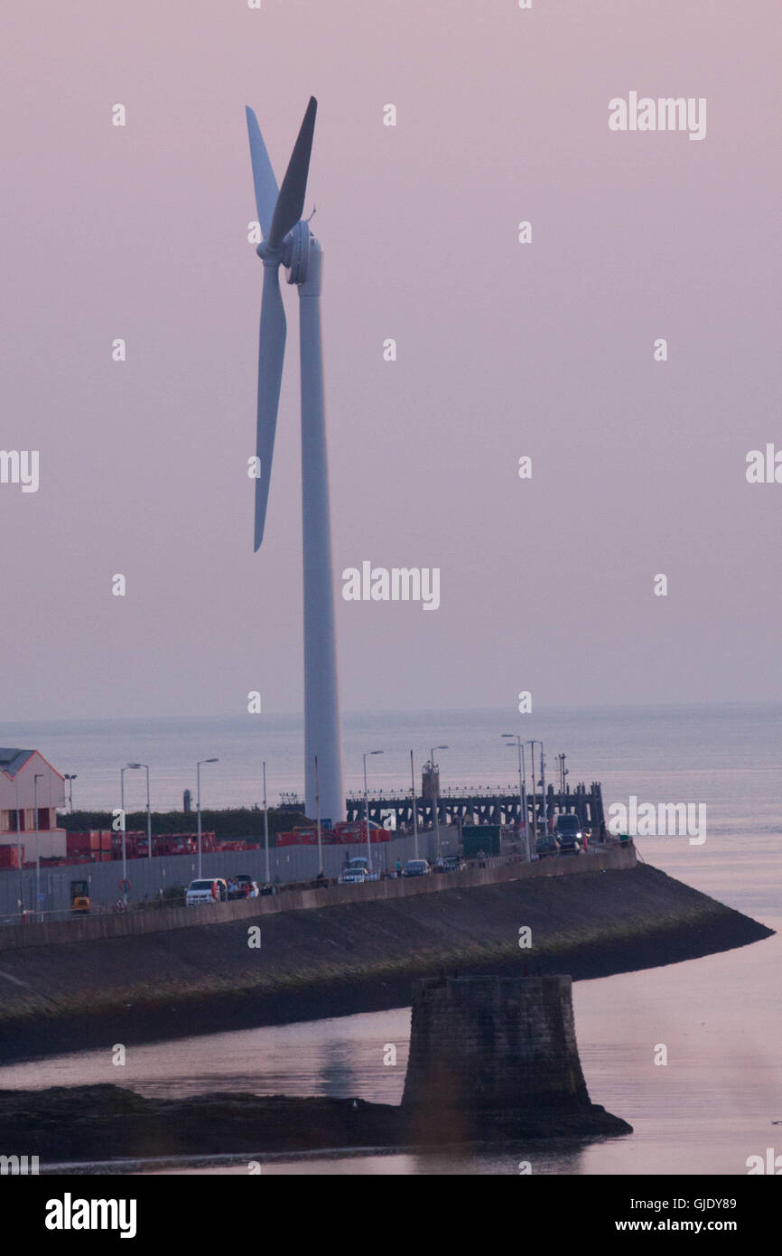 Heysham, Lancashire, United Kingdom. 15th Aug, 2016. Photographed in the late evening sun is the new 77m high wind turbine that has been errected on the North Quay at Heysham Harbour which was completed today. The Turbine which is being errected by Peel Energy Credit:  David Billinge/Alamy Live News Stock Photo
