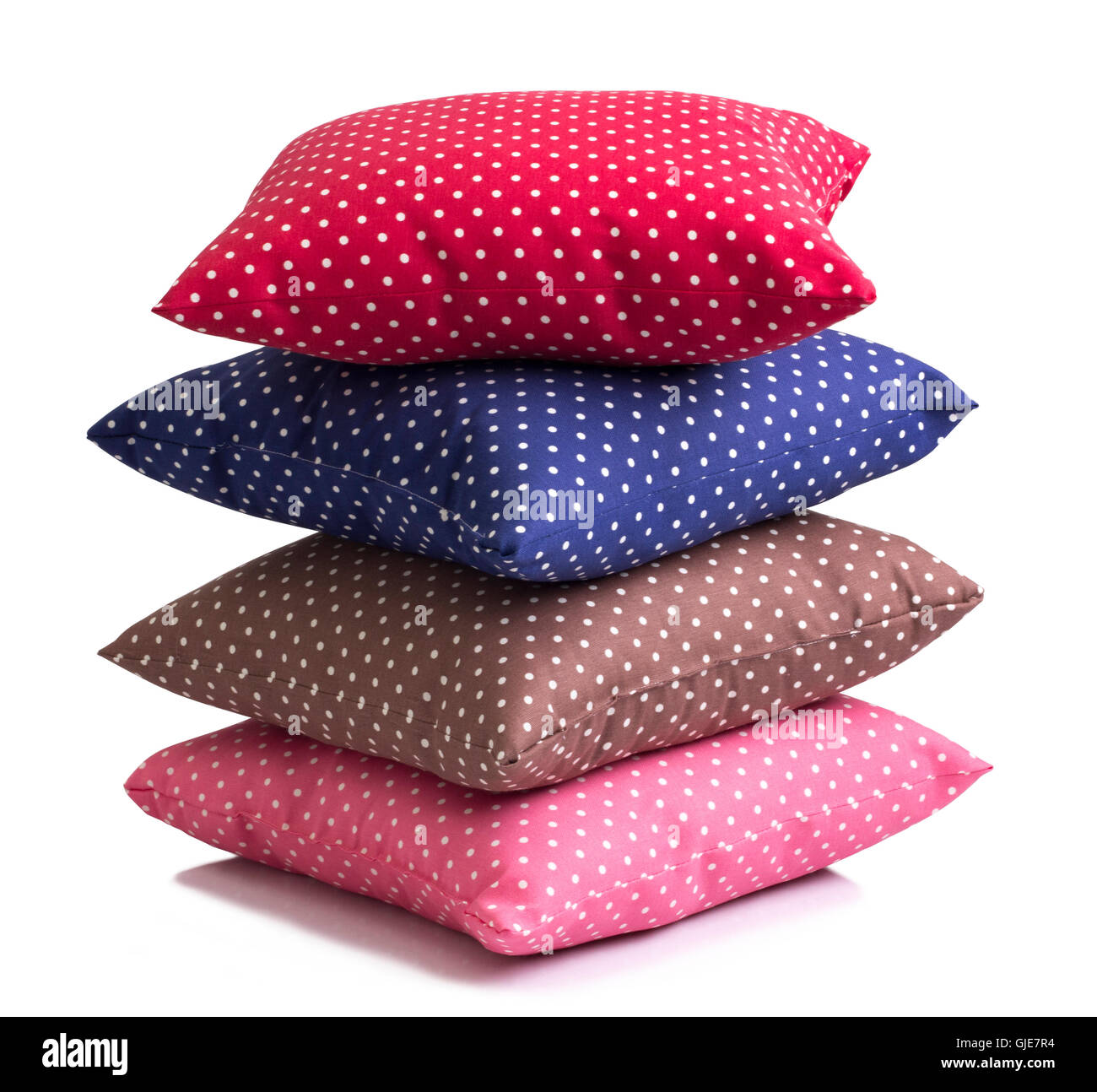 Stack of polka dot cushions isolated on white background Stock Photo