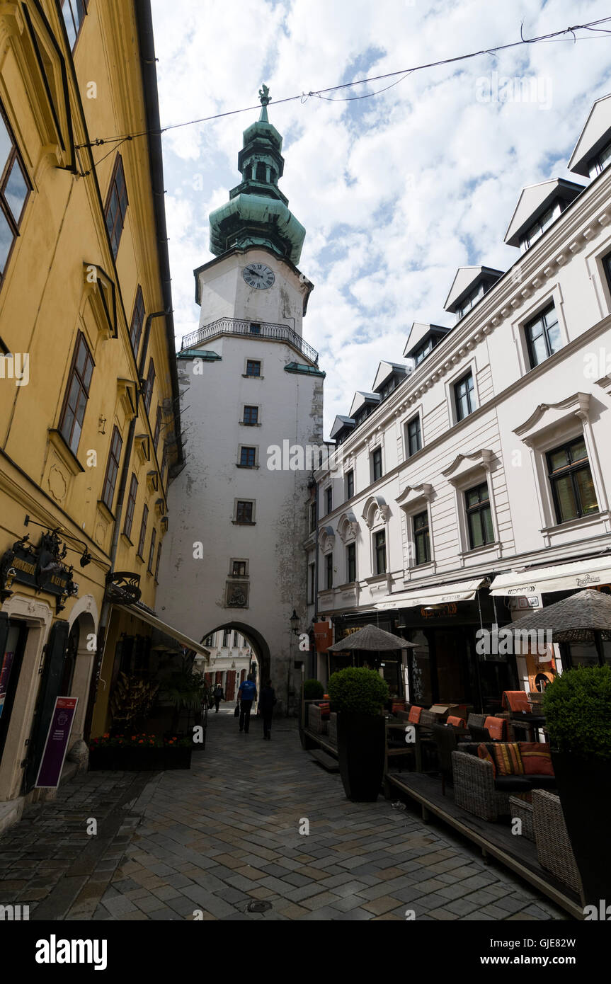 Michalska ulica  ( Michalska Street )  lined with open-air restaurants and Saint Michael's Gate tower in Bratislava old town, Stock Photo