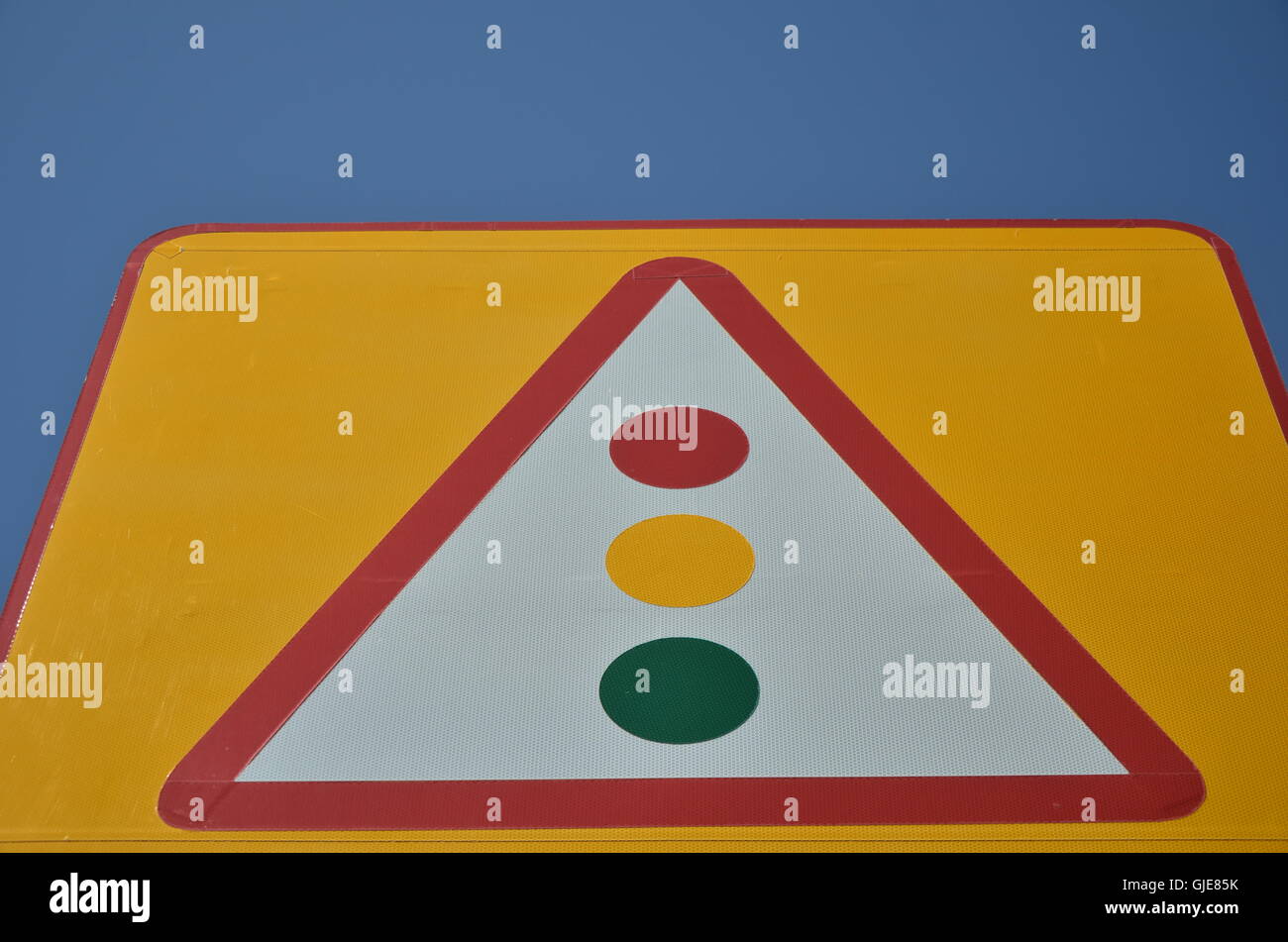 Traffic Light on Yellow Sign Board Stock Photo