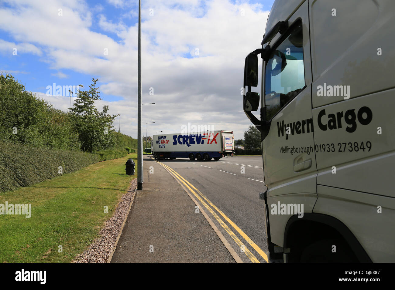 A screwfix lorry turns out onto the road from a depot in the UK Stock Photo