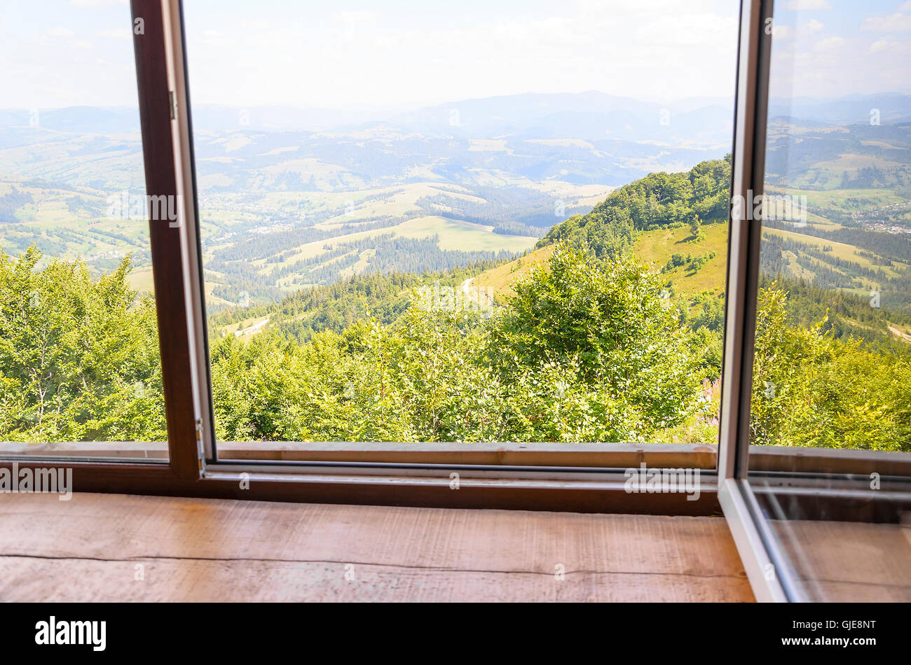 The old window with views of the beautiful mountains. Stock Photo