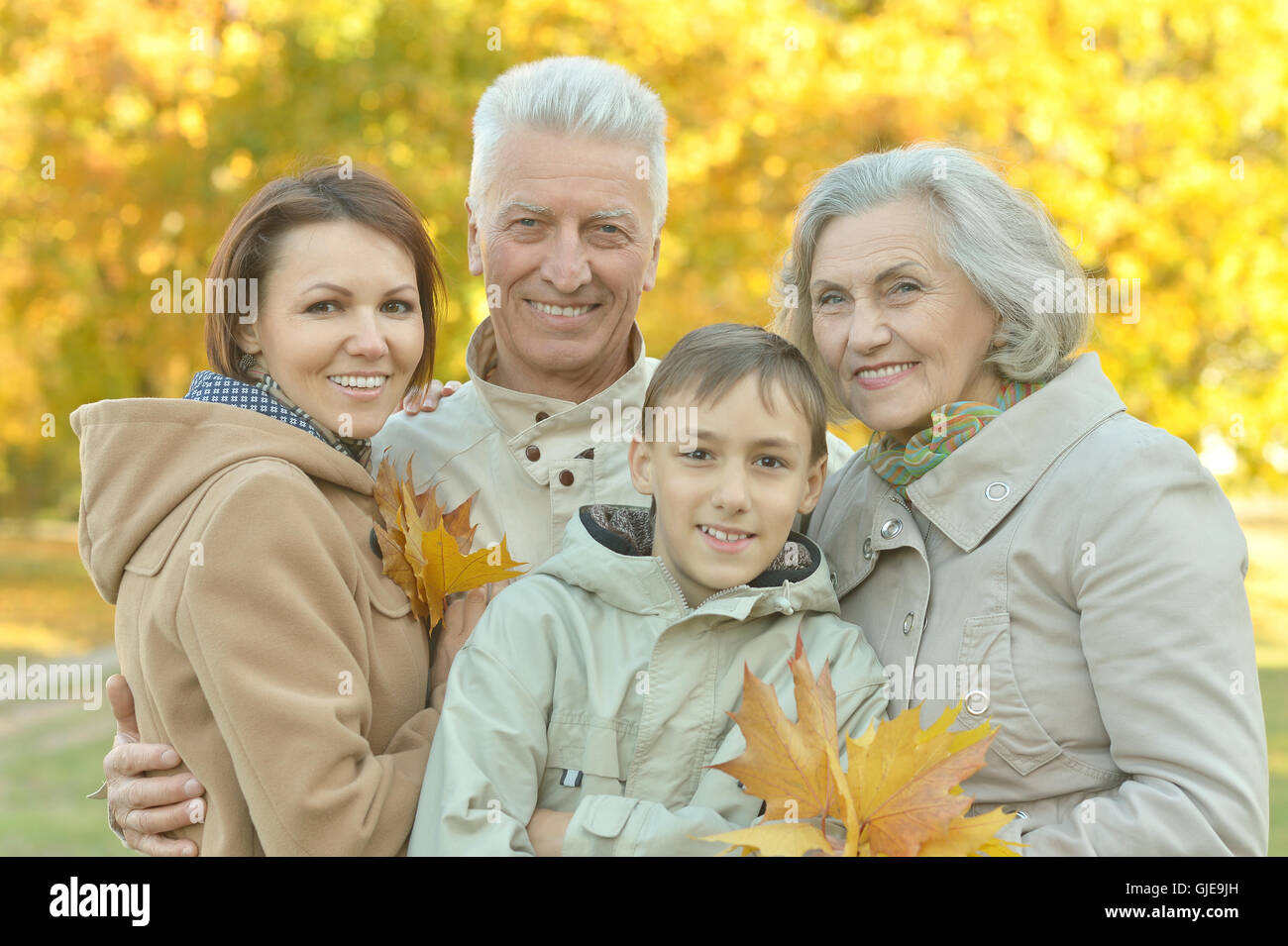 Happy family resting in park Stock Photo - Alamy