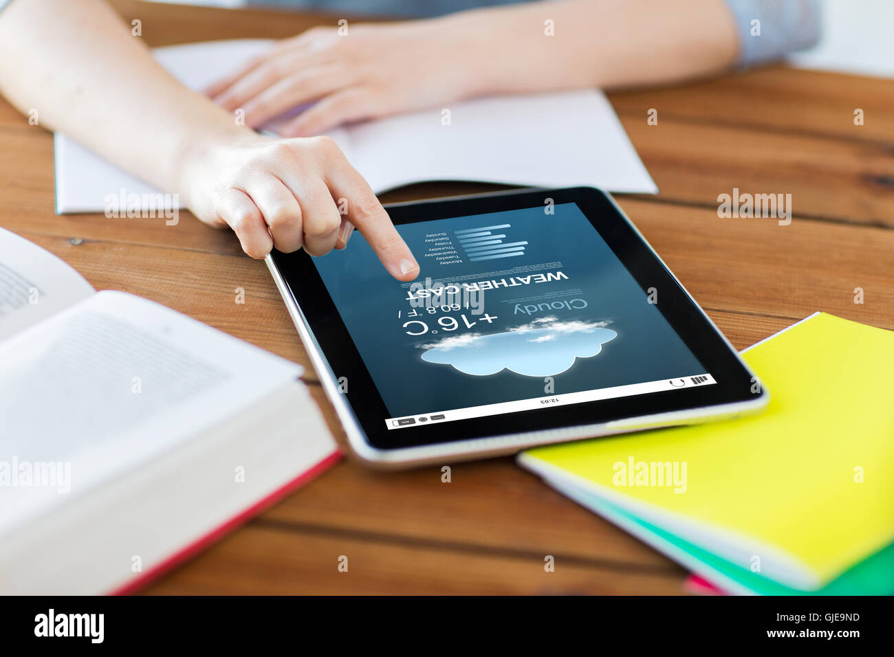 close up of student with tablet pc and notebook Stock Photo