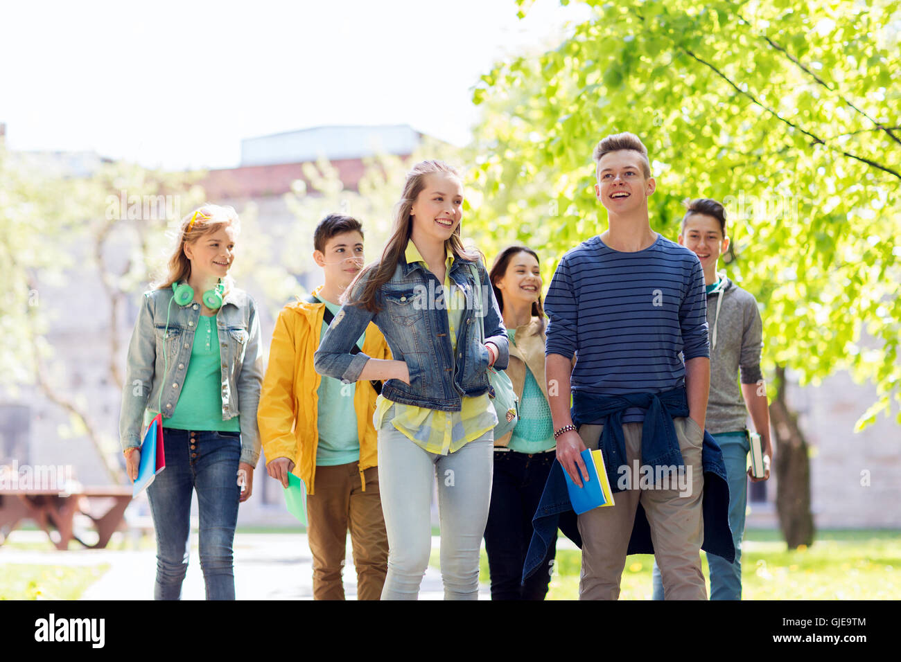 group of happy teenage students walking outdoors Stock Photo - Alamy