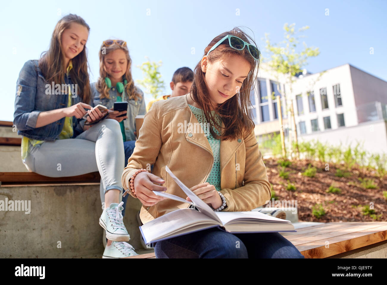 high school student girl reading book outdoors Stock Photo - Alamy
