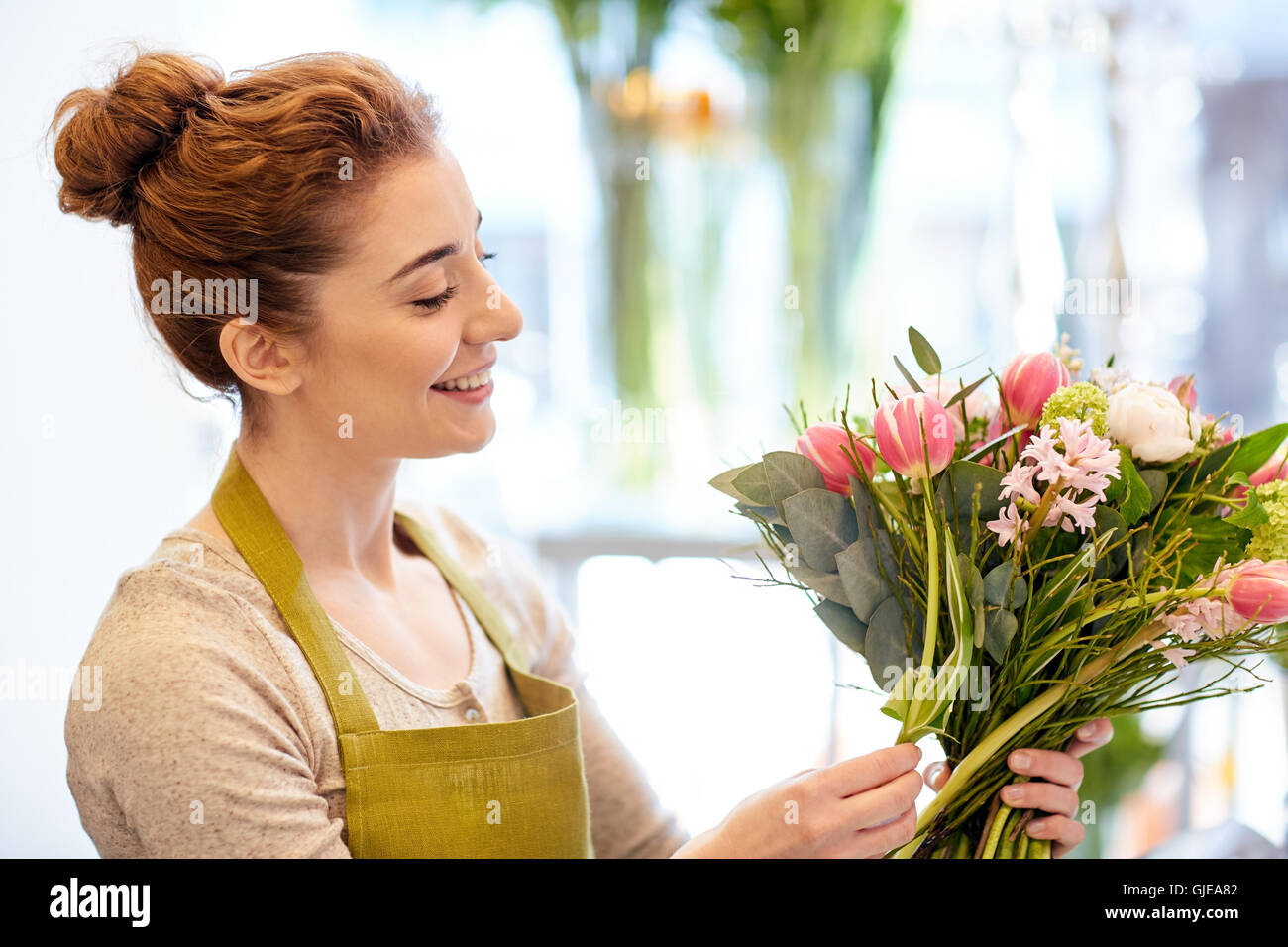 smiling florist woman making bunch at flower shop Stock Photo - Alamy