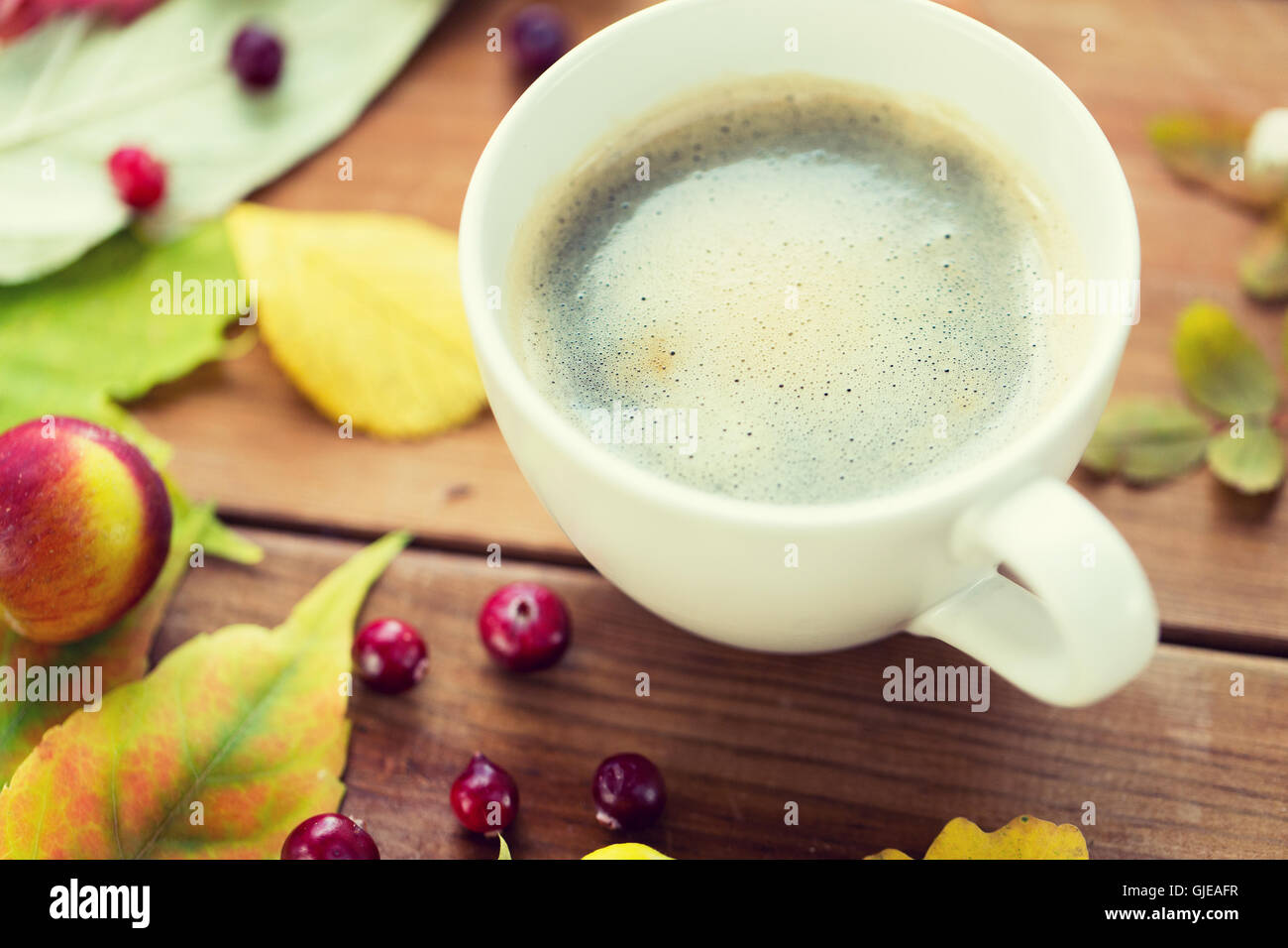 close up of coffee cup on table with autumn leaves Stock Photo - Alamy