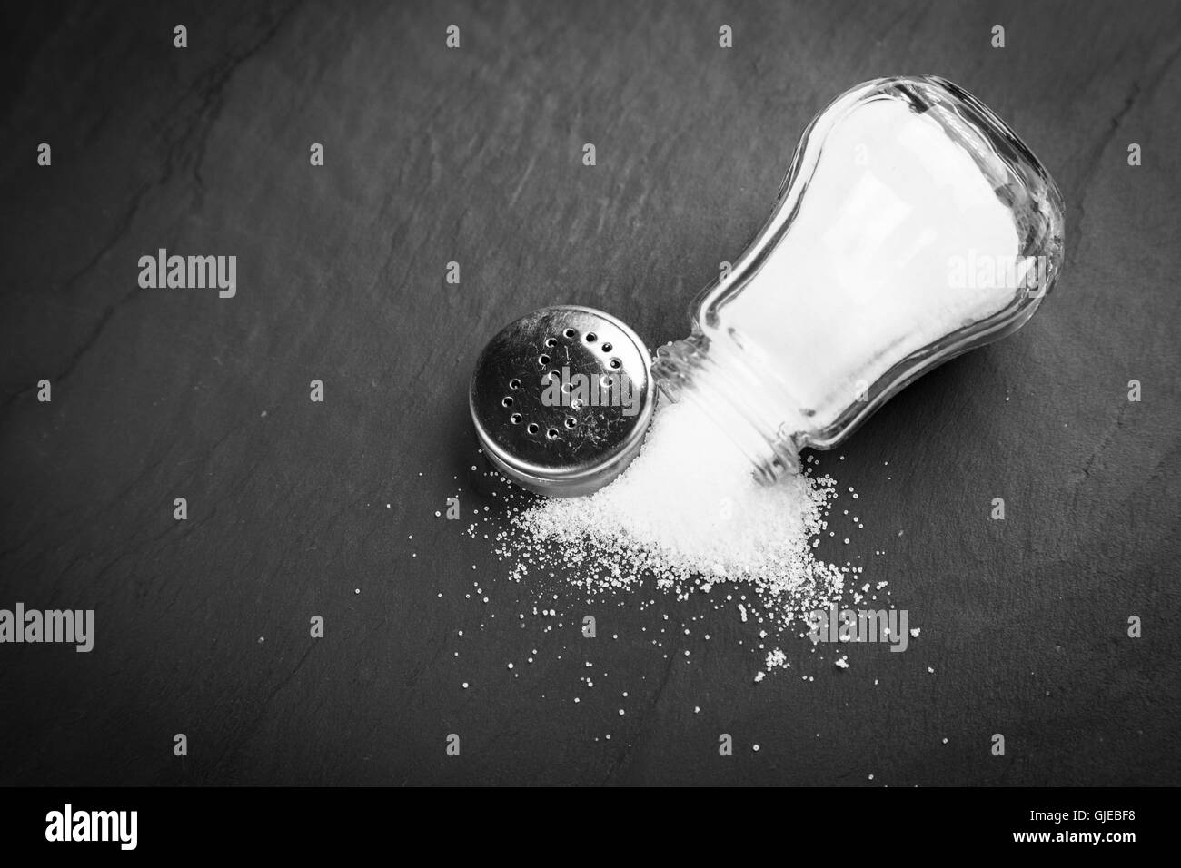 Salt shaker on slate board Stock Photo Alamy