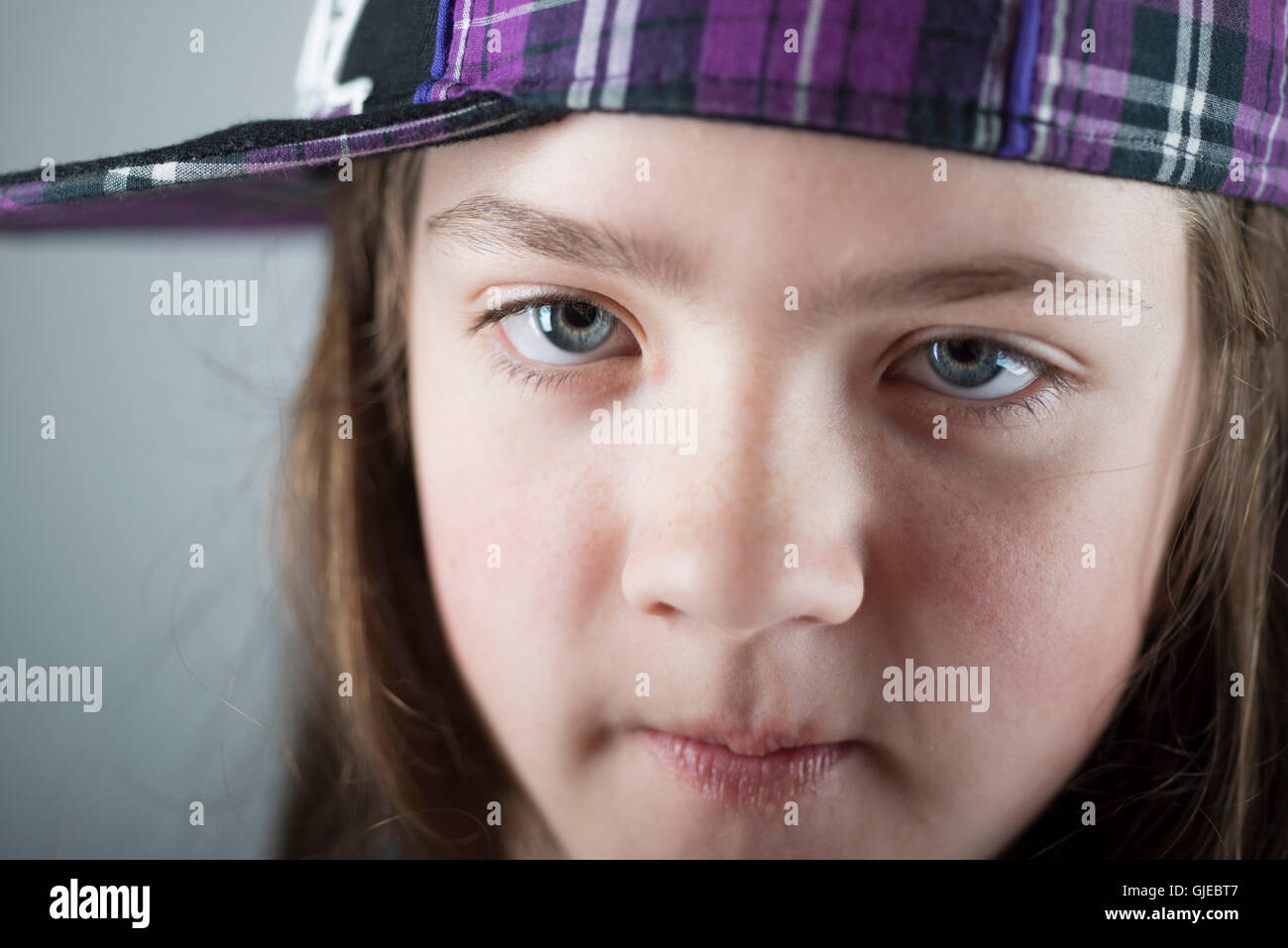 closeup portrait of girl in checkered cap Stock Photo