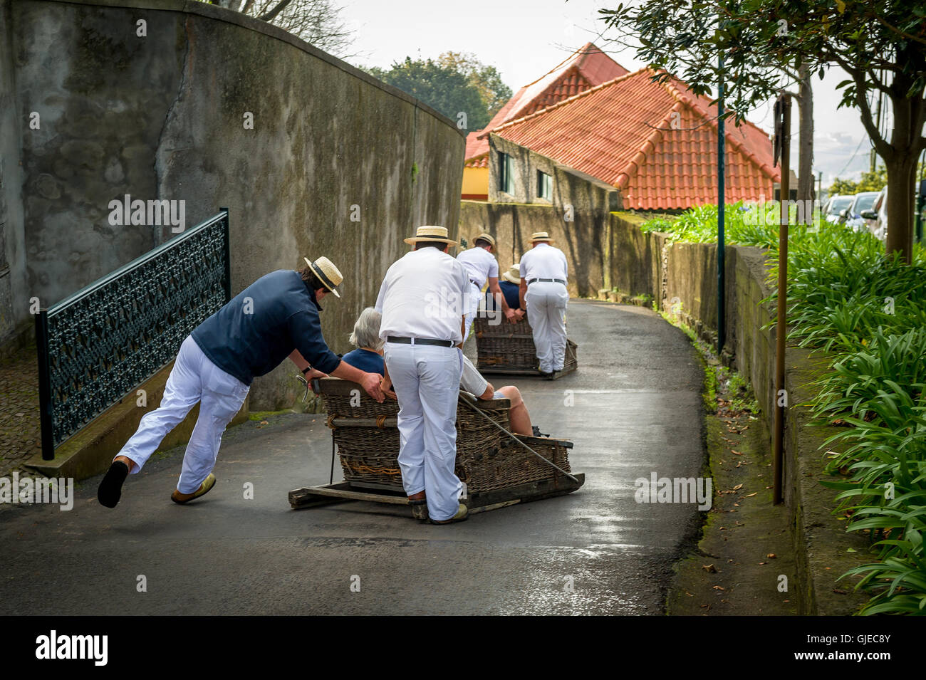 Funchal traditional sledge downhill riders in Monte park Stock Photo