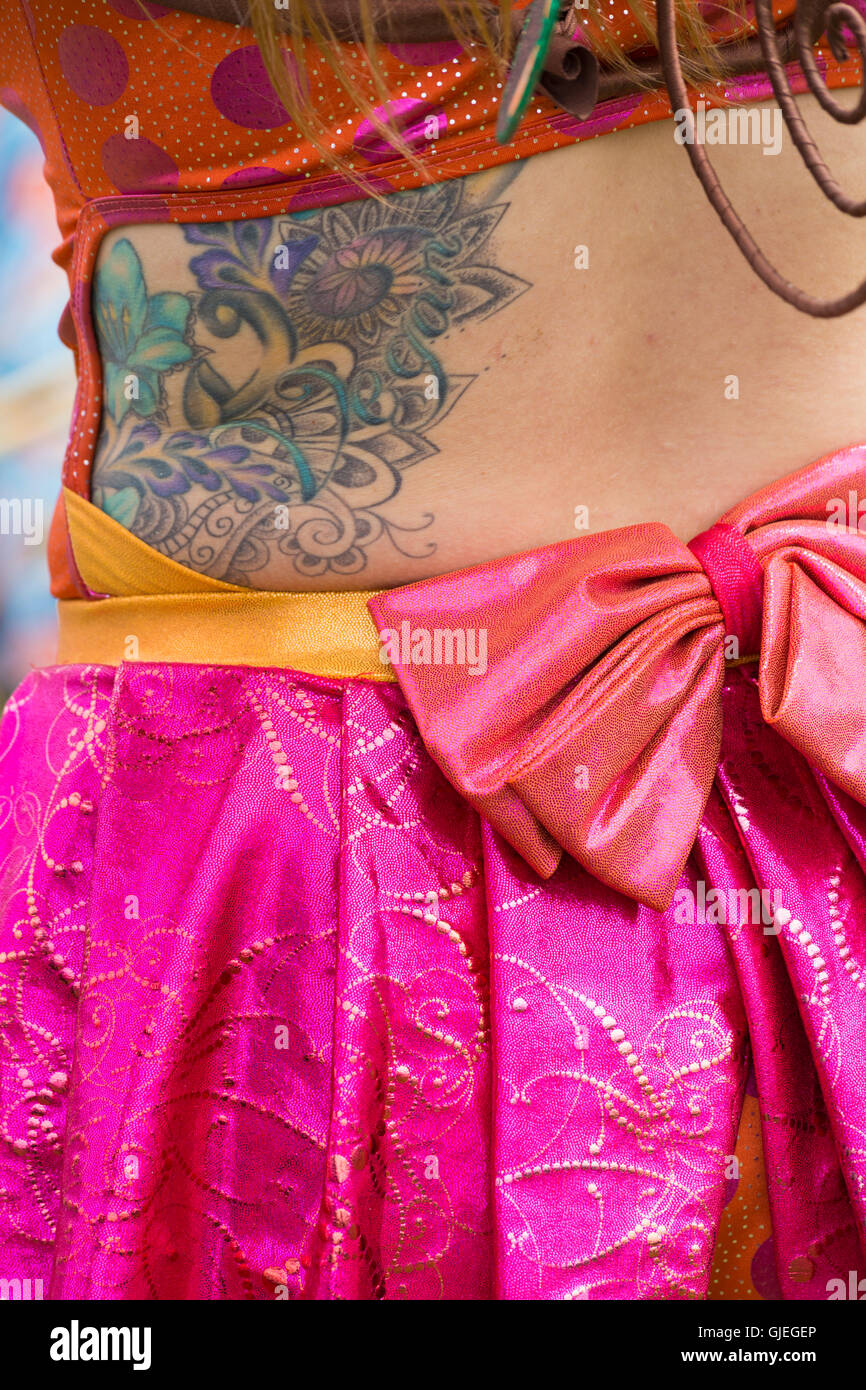 Colourful Vegan tattoo on side of entertainer at the New Forest Fairy Festival at Burley, Hampshire, UK in August Stock Photo