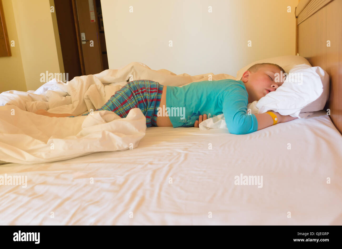 boy sleeps with a bracelet in a hotel in a great beds Stock Photo Alamy