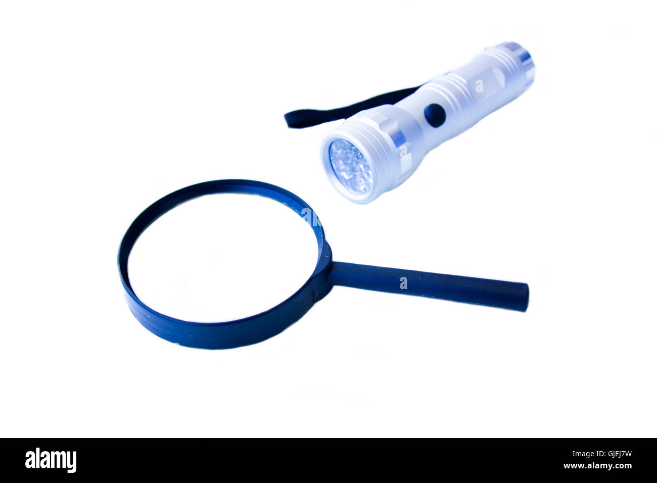 Magnifying glass and flashlight on a white background Stock Photo