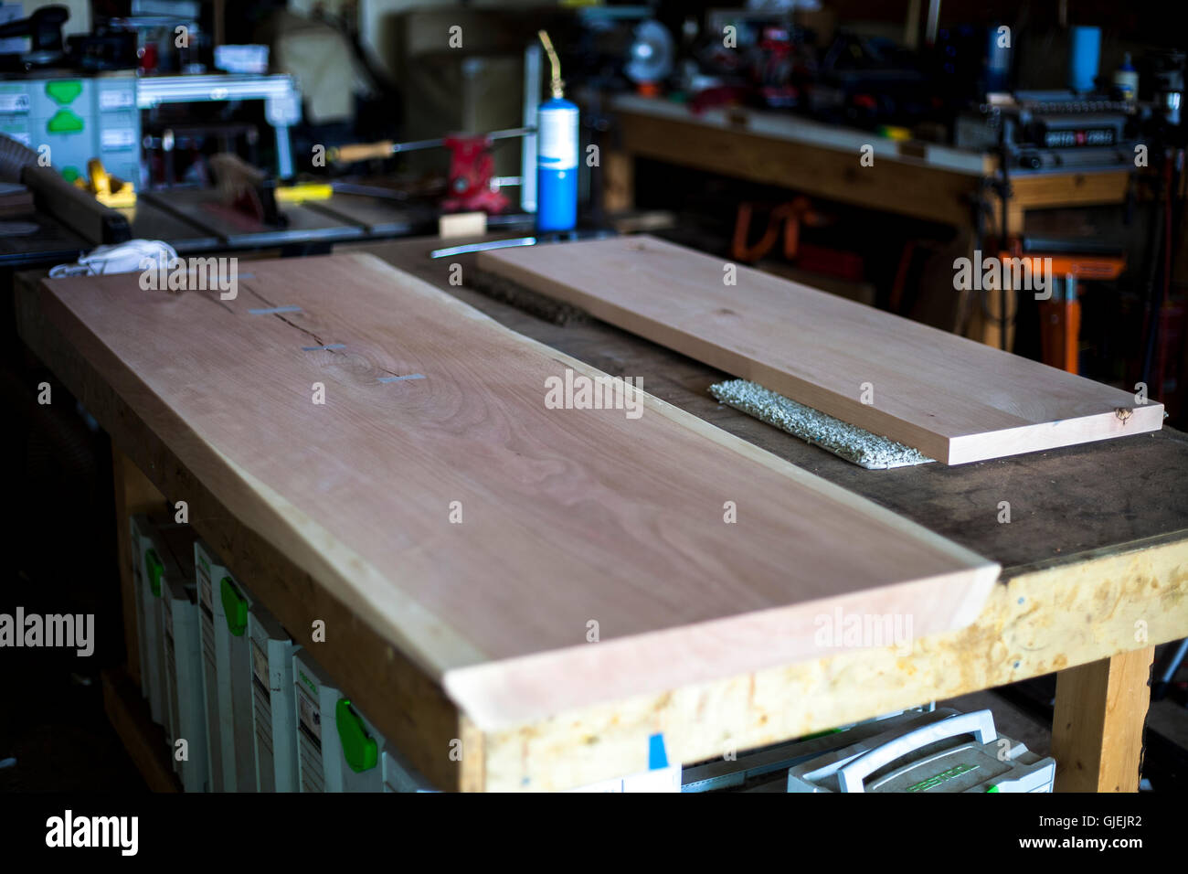 Custom wood table top awaiting stain and assembly Stock Photo - Alamy