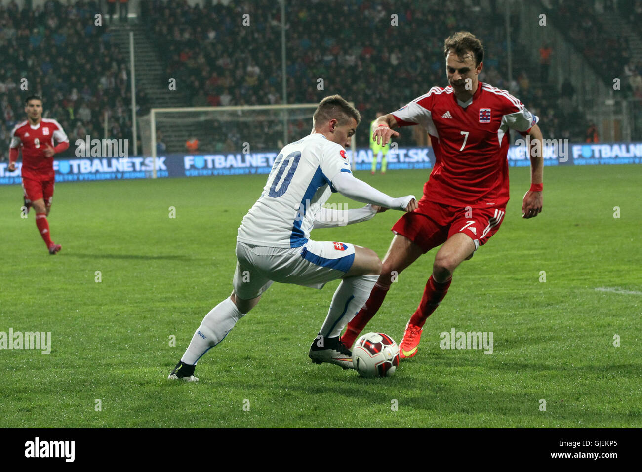 Robert Mak (left) and Lars Gerson (7) vie for the ball during the EURO 2016 qualifier Slovakia vs Luxembourg 3-0. Stock Photo