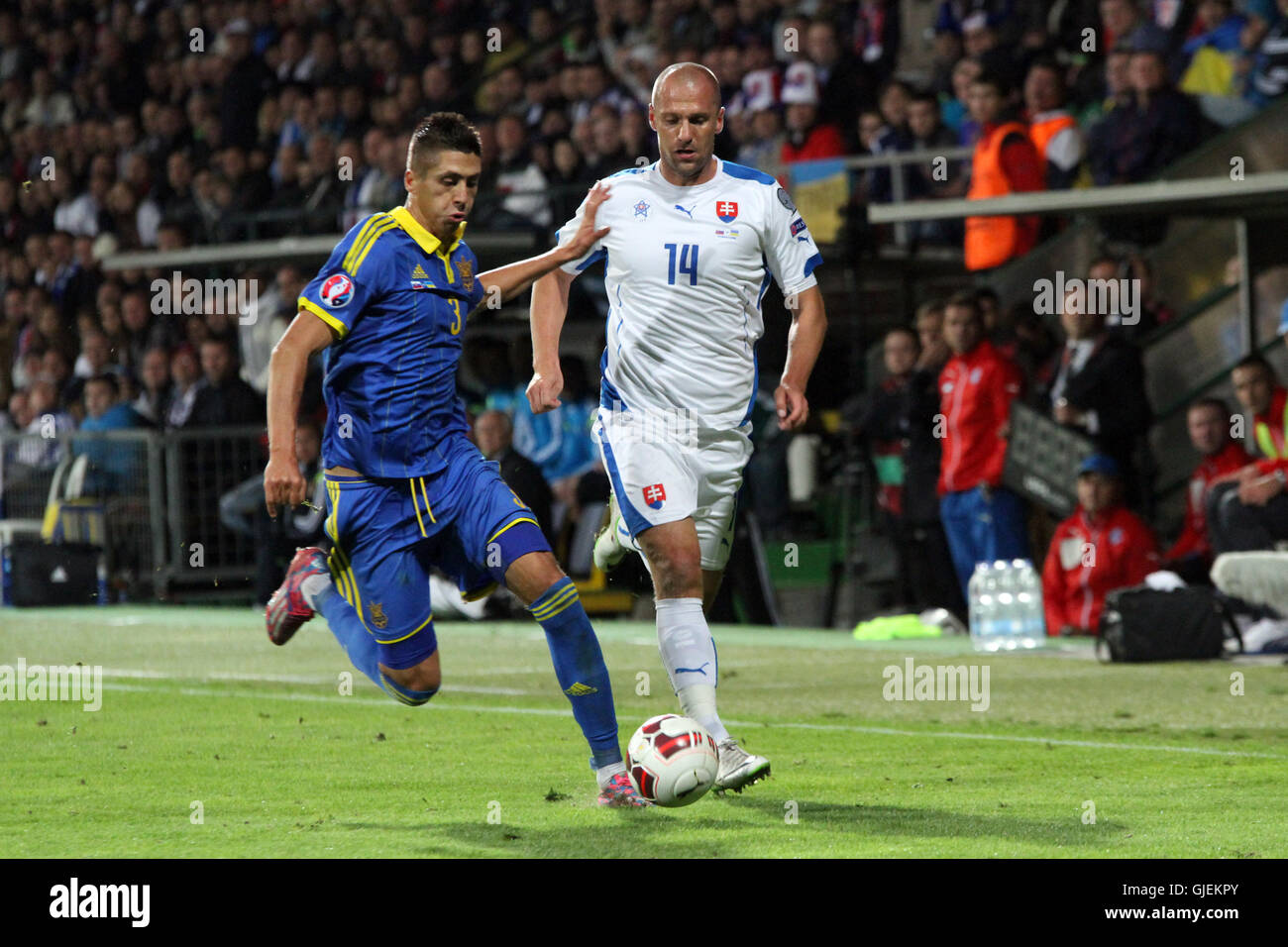 Yevhen Khacheridi (left) and Martin Jakubko (right) vie for the ball during the EURO 2016 qualifier Slovakia vs Ukraine 0-0. Stock Photo