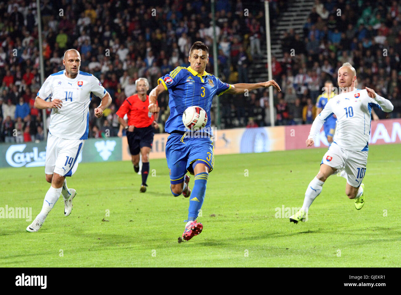 Yevhen Khacheridi (3) between Martin Jakubko (14) and Miroslav Stoch (10) during the EURO 2016 qualifier Slovakia vs Ukraine 0-0 Stock Photo