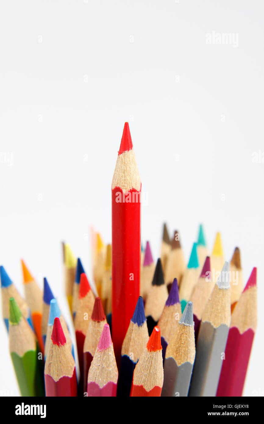 Red pencil standing out from others Stock Photo