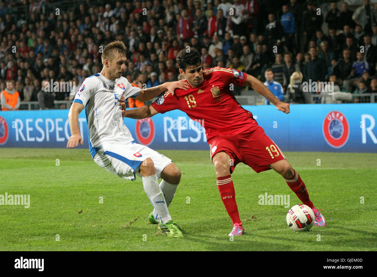 Norbert Gyomber (left) and Diego Costa (right) during EURO 2016 qualifier Slovakia vs Spain 2-1. Stock Photo