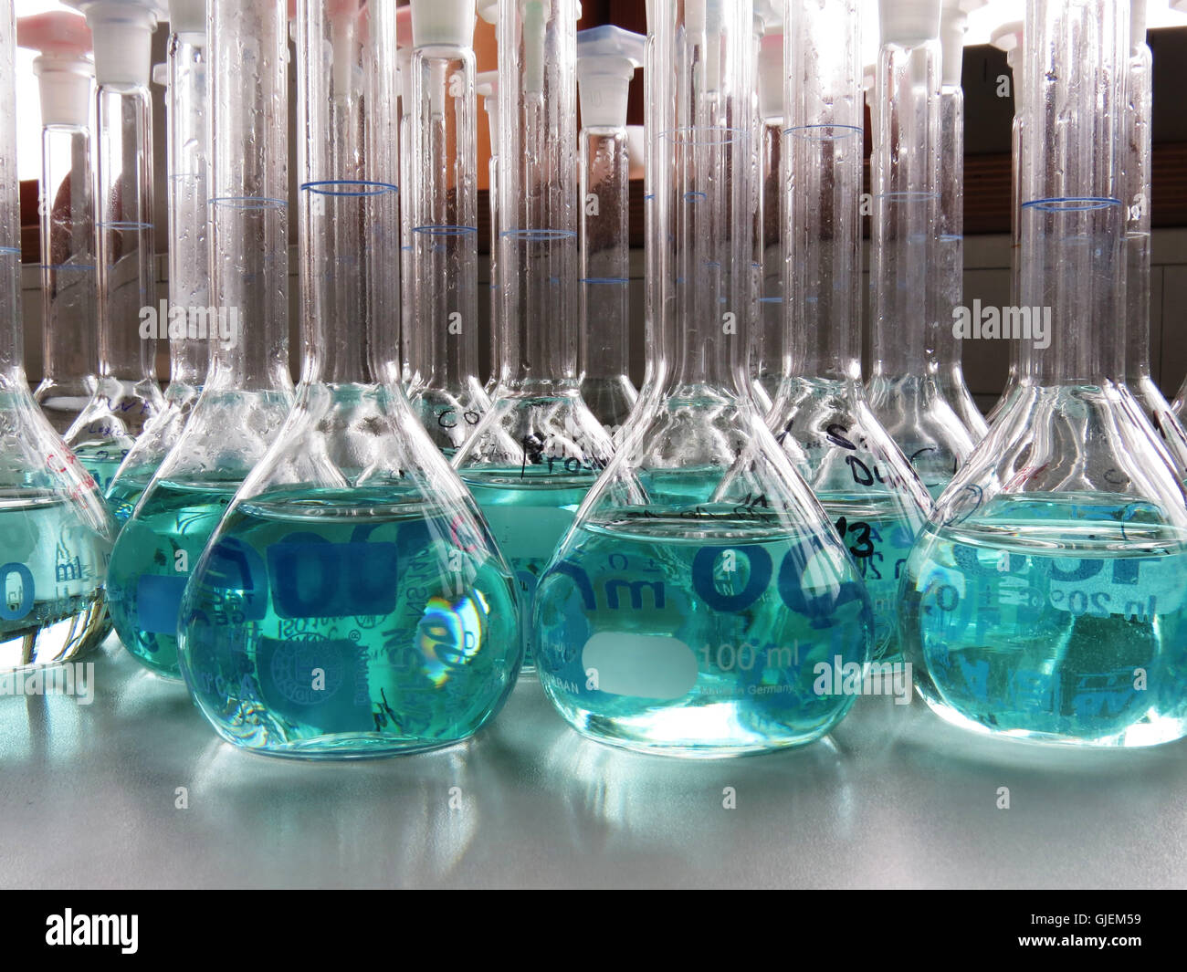 many chemical flasks with blue solution waiting for analysis Stock Photo