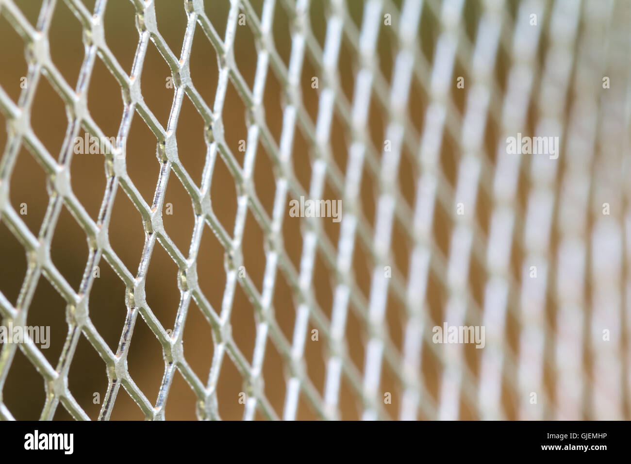 Metal grid fence panel close up with blur Stock Photo - Alamy