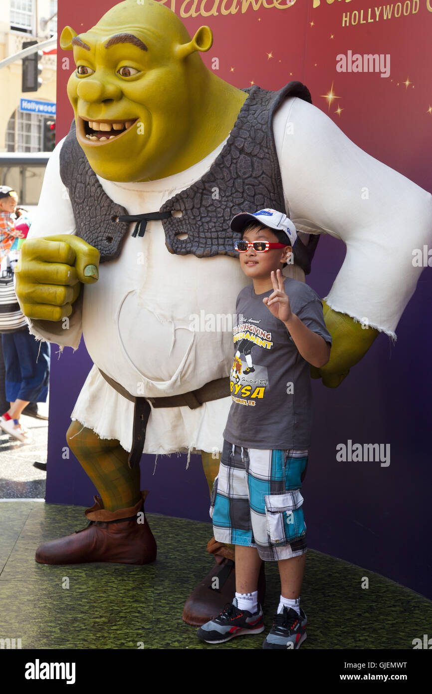posing with Shrek wax figure at Madame Tussaud's, Hollywood Boulevard, Hollywood, Los Angeles, California, USA Stock Photo